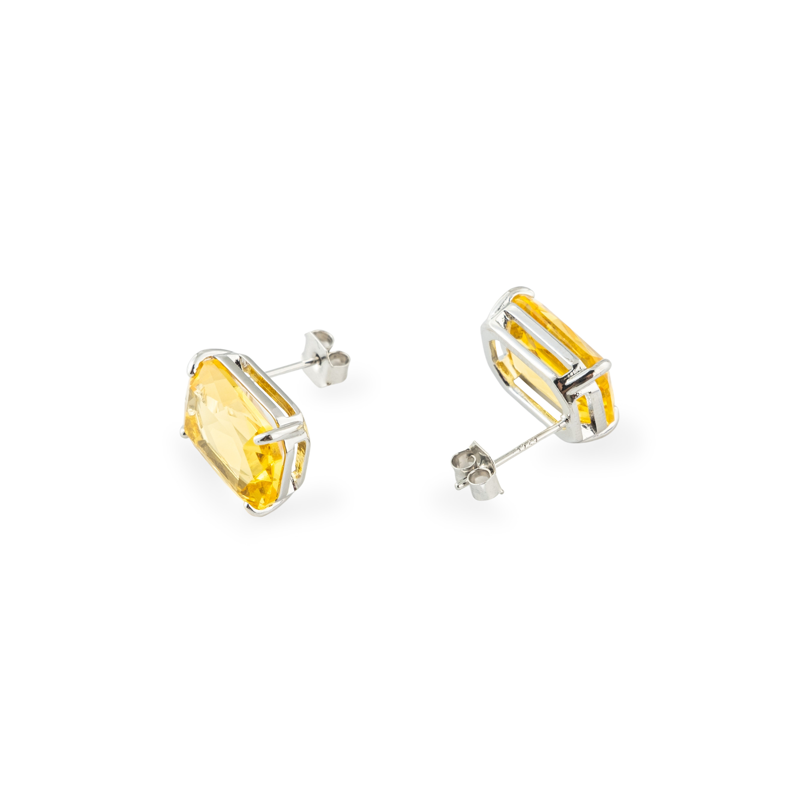 Silver stud earrings with a large yellow crystal