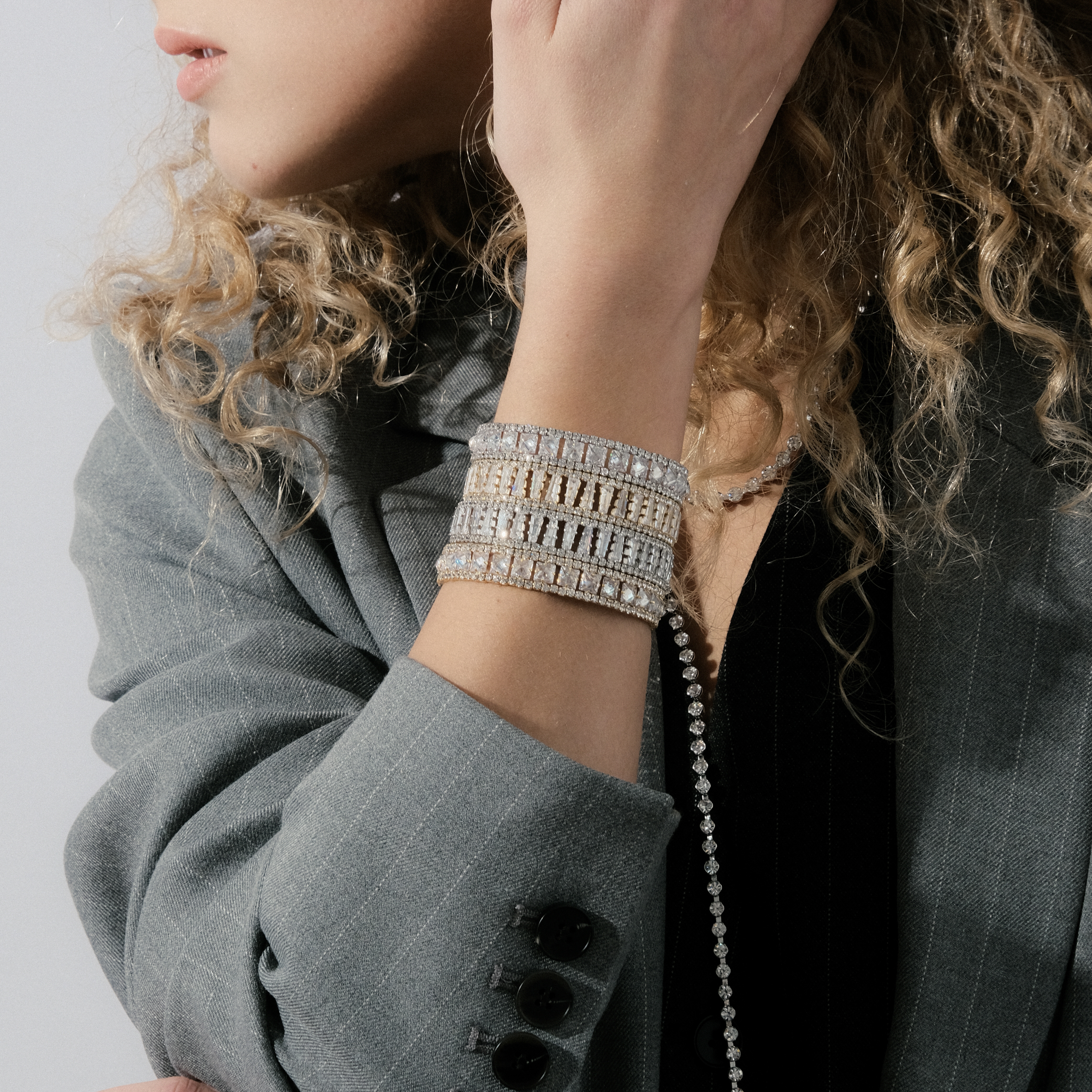 Golden open bracelet with rectangular crystals