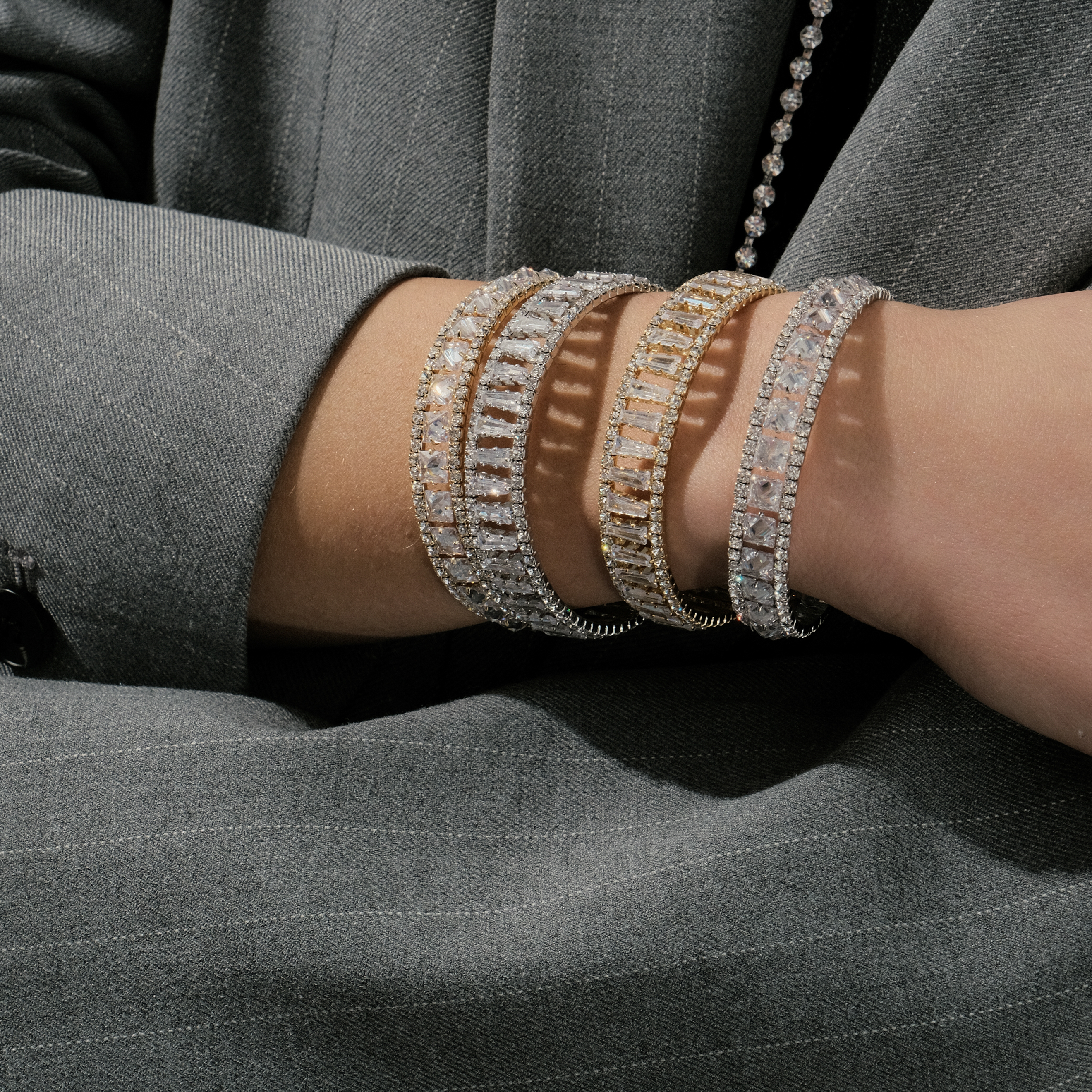 Golden open bracelet with rectangular crystals