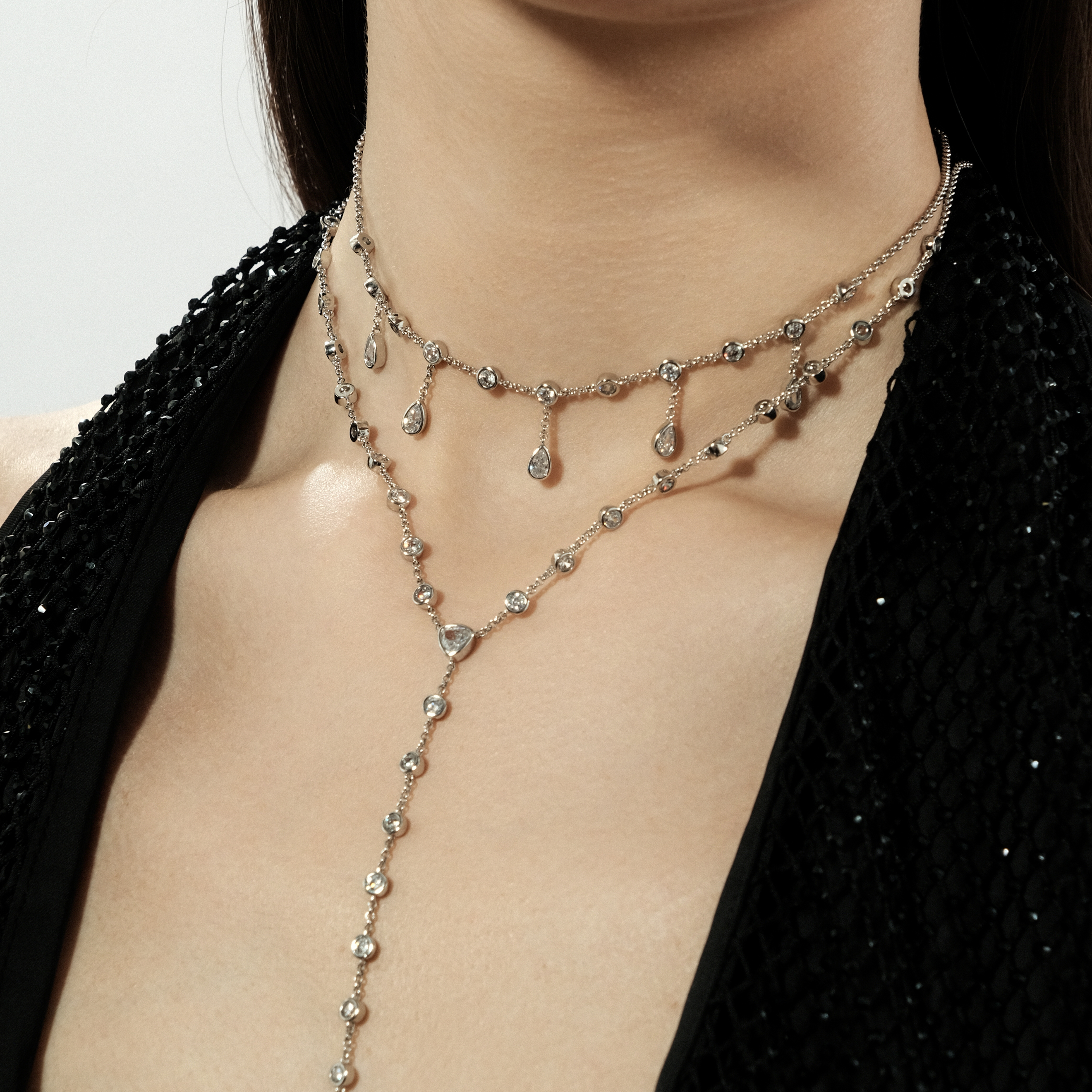 Silvery long necklace with a cross completely covered with crystals