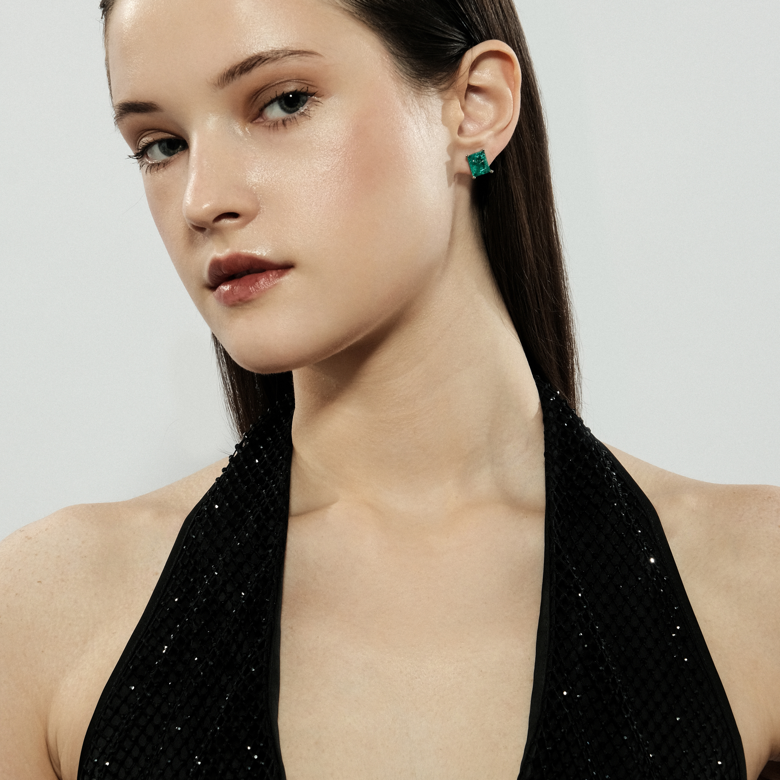 Silver stud earrings with light green crystal