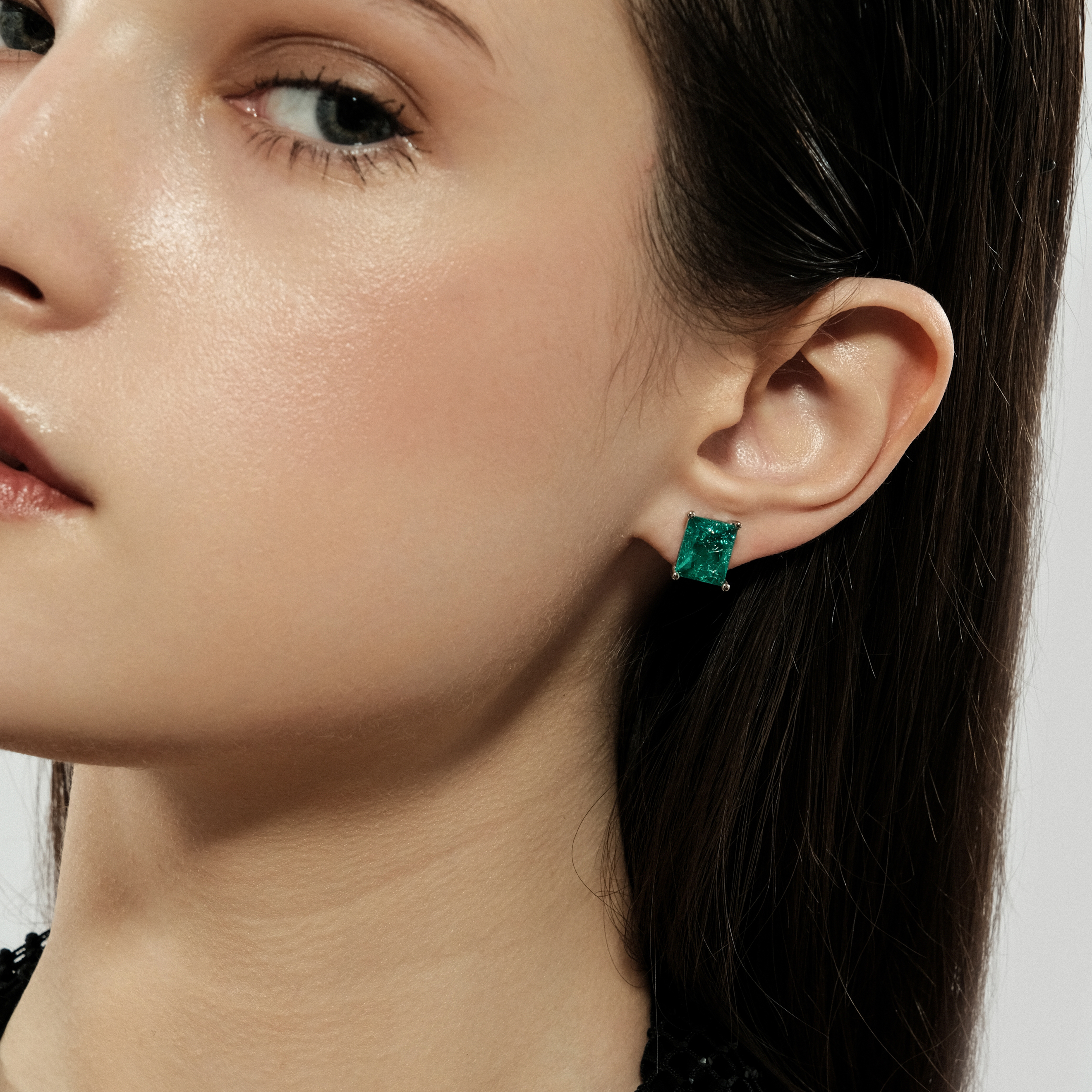 Silver stud earrings with light green crystal