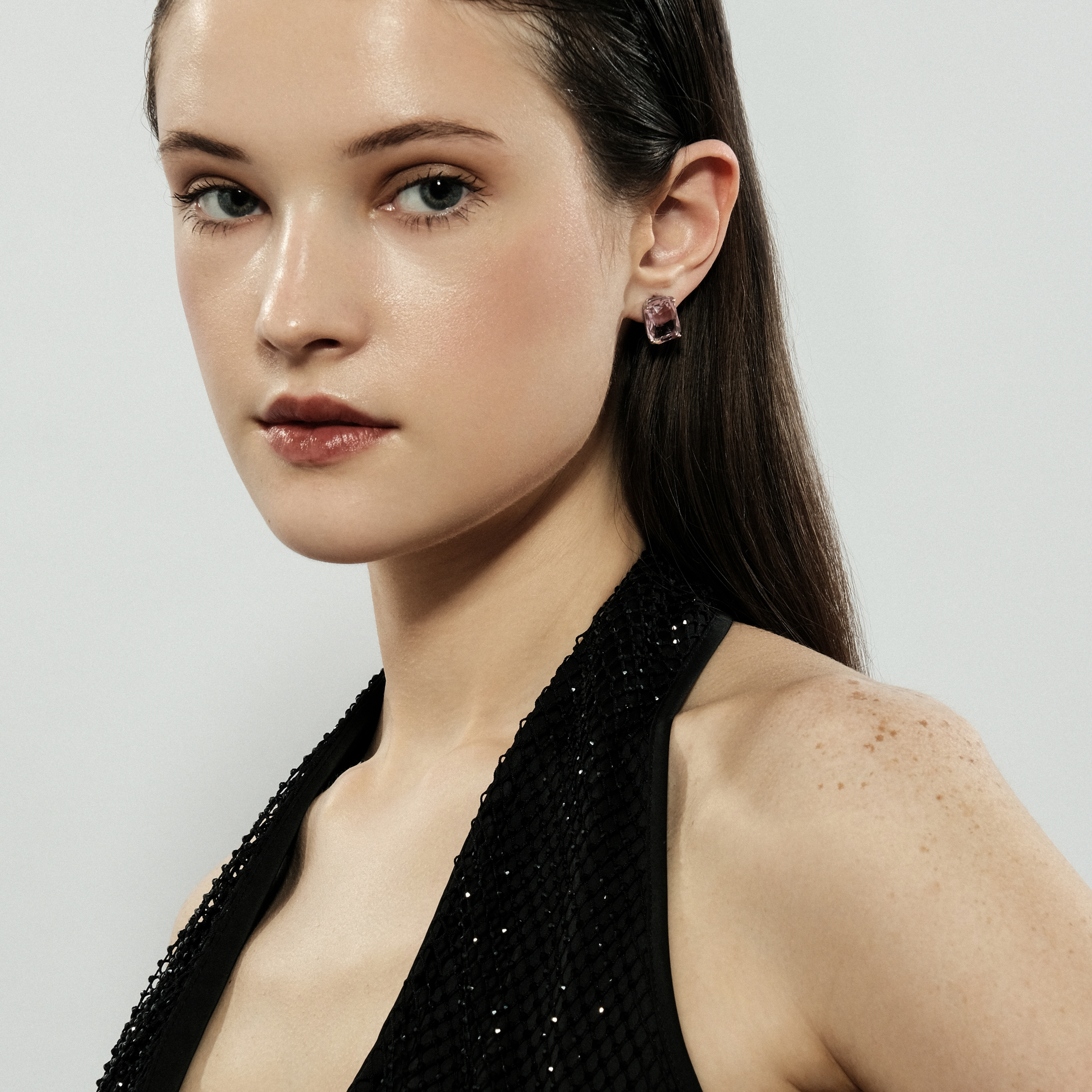 Silver stud earrings with a large pink crystal