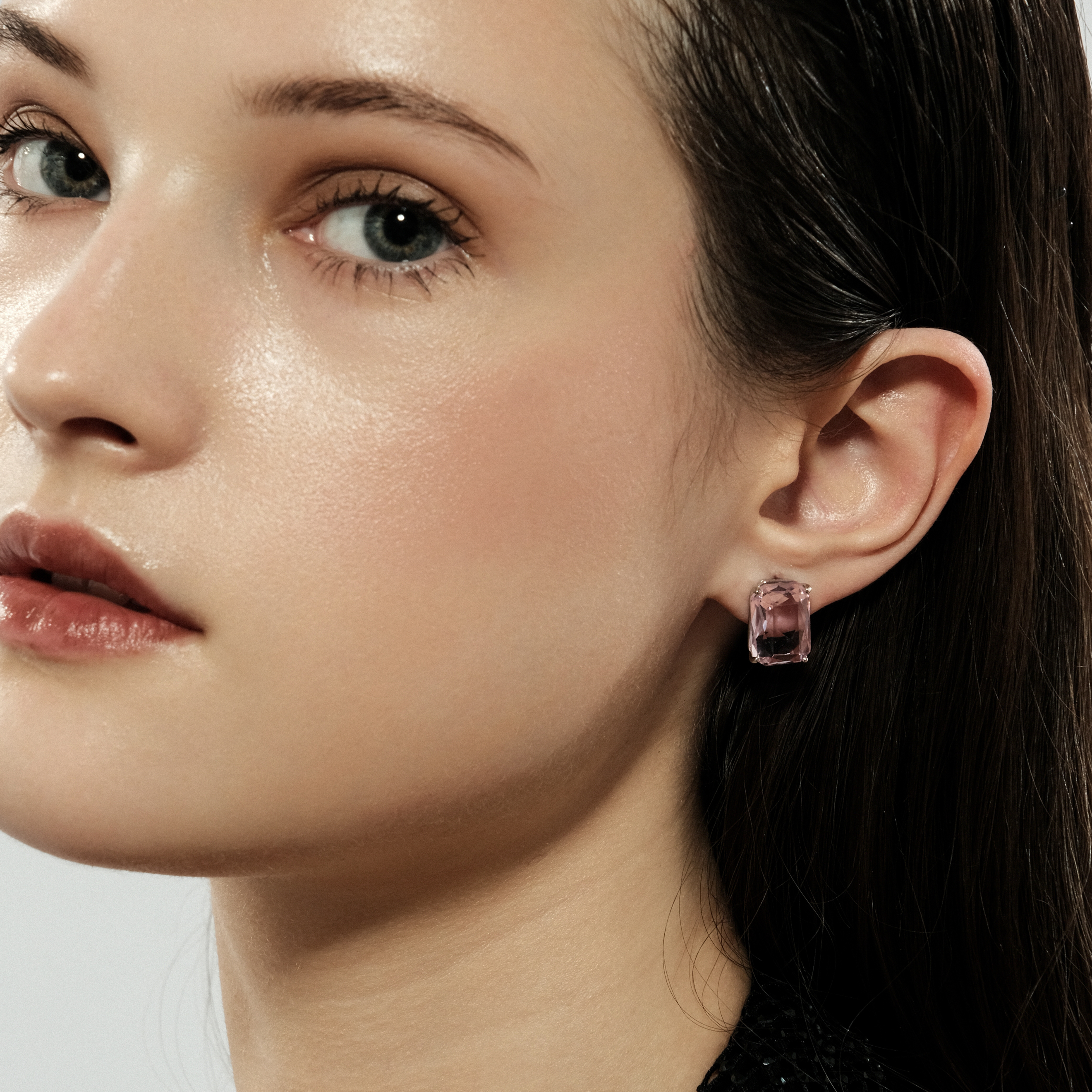 Silver stud earrings with a large pink crystal