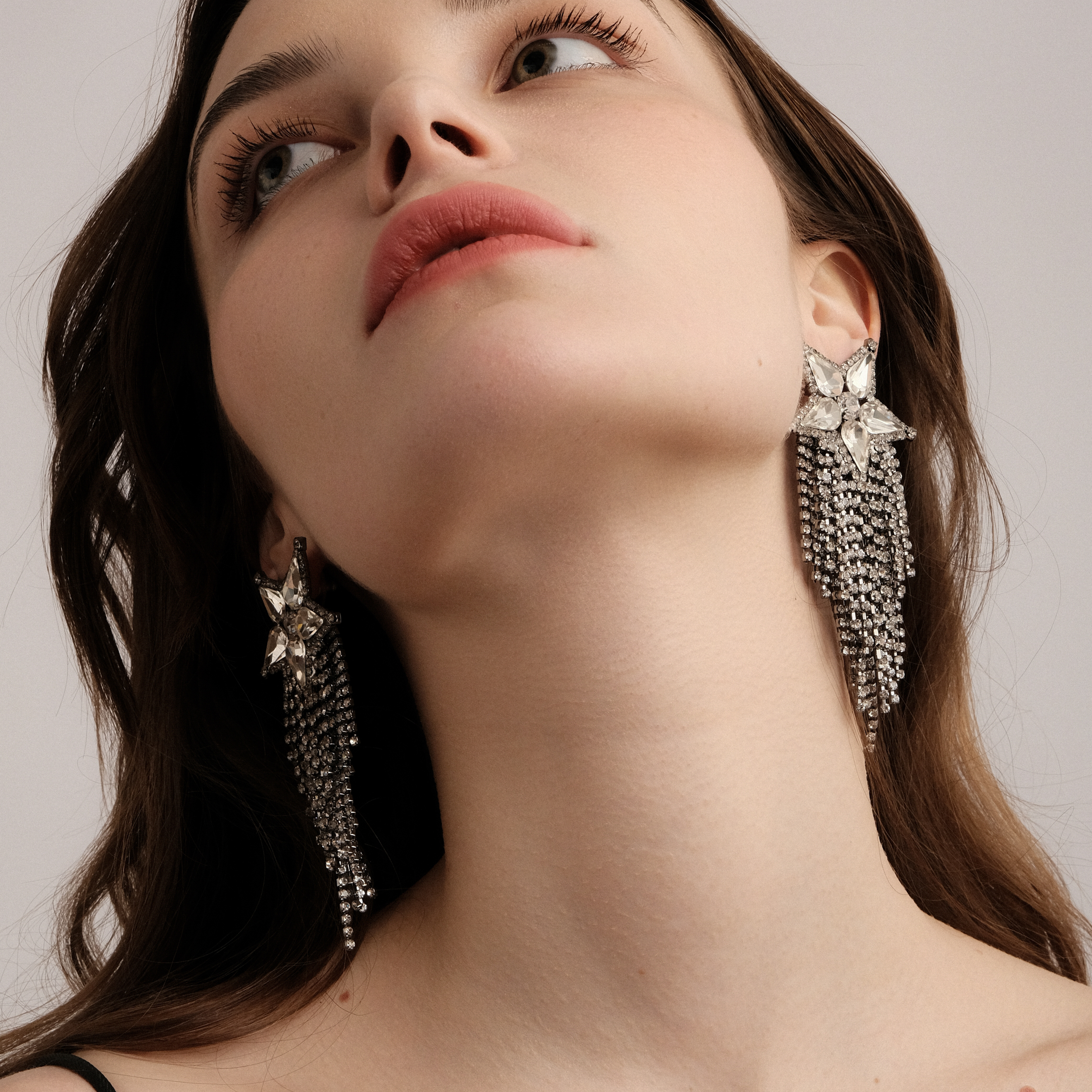 Blackened star earrings completely covered with crystals