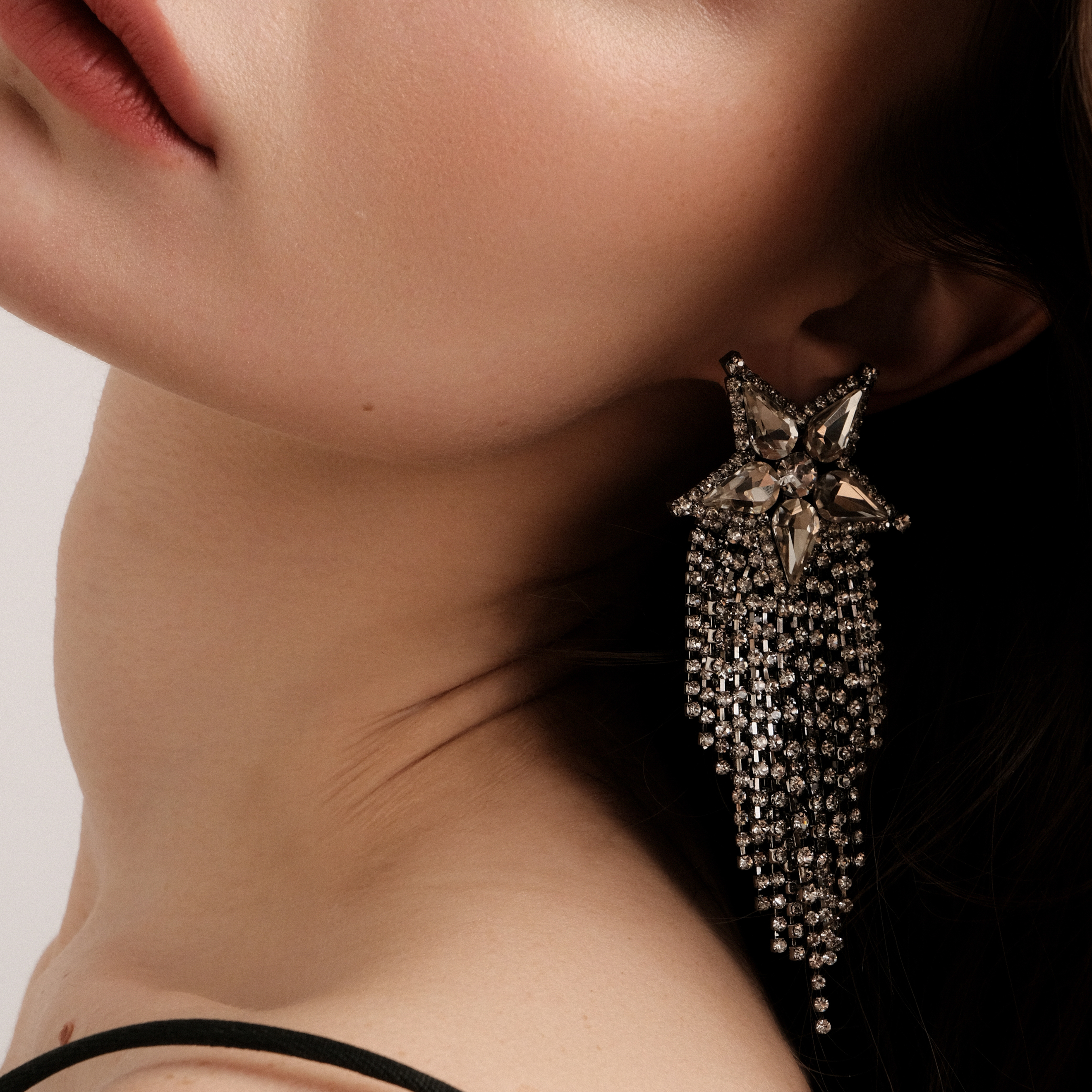 Blackened star earrings completely covered with crystals