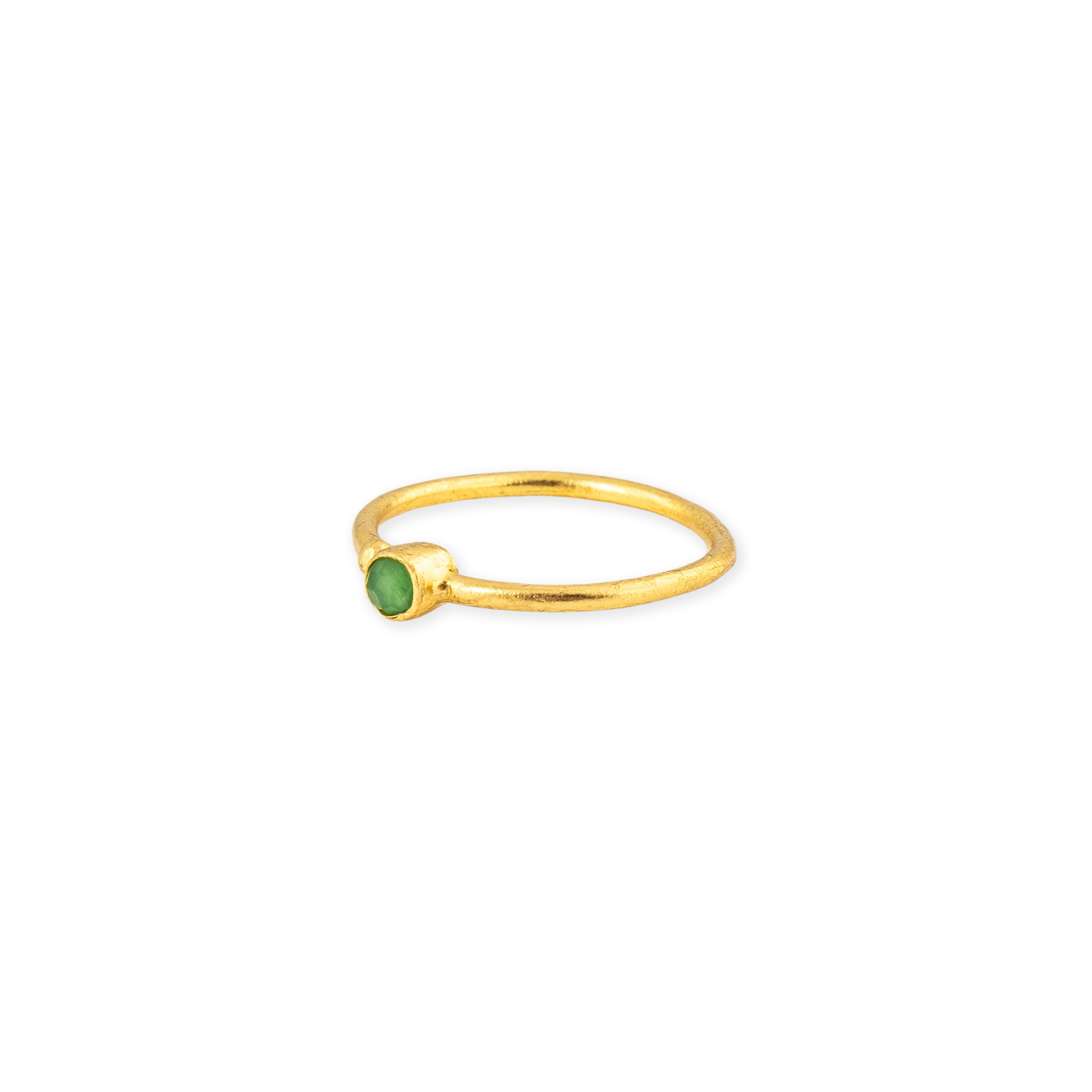 A thin golden ring with a green stone