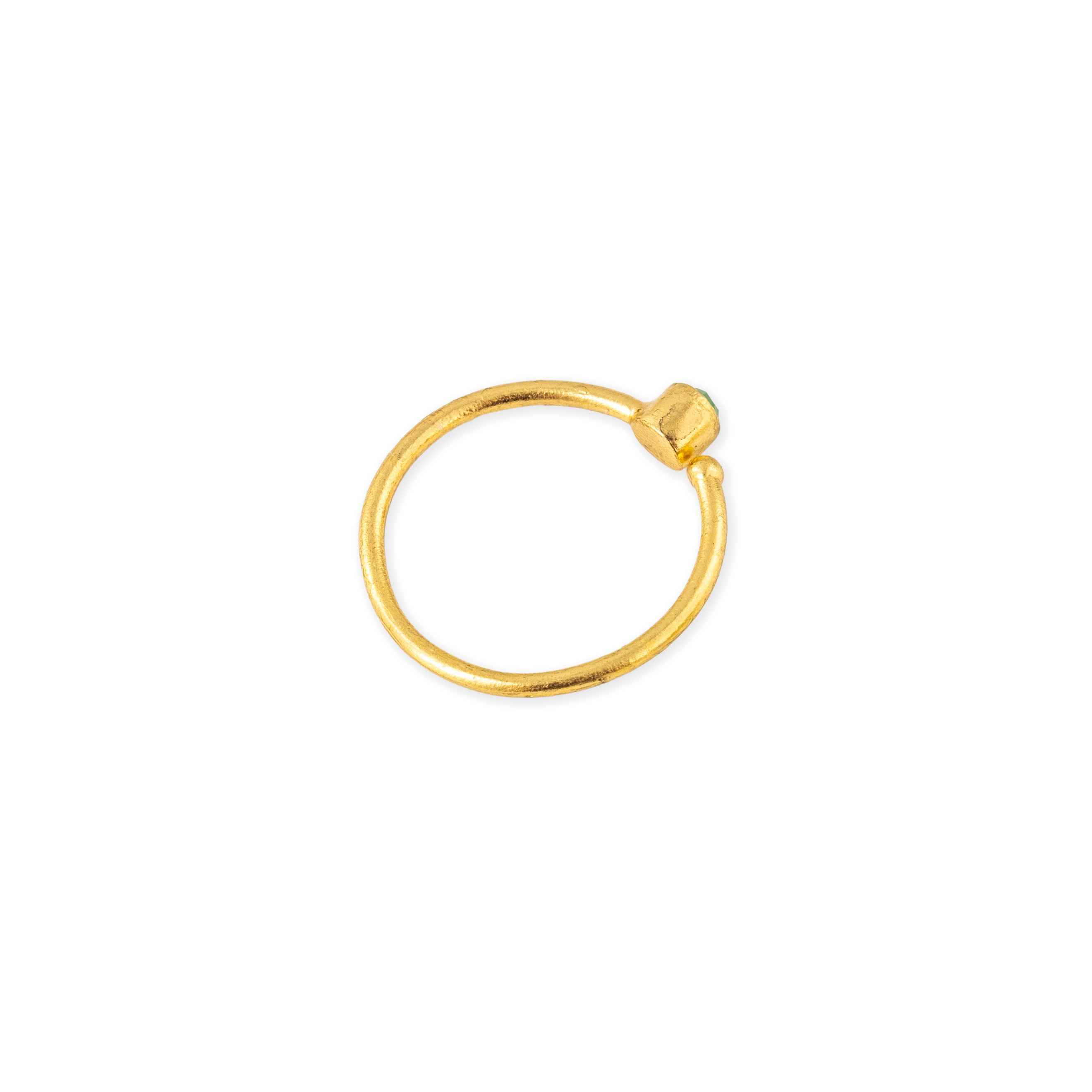 A thin golden ring with a green stone