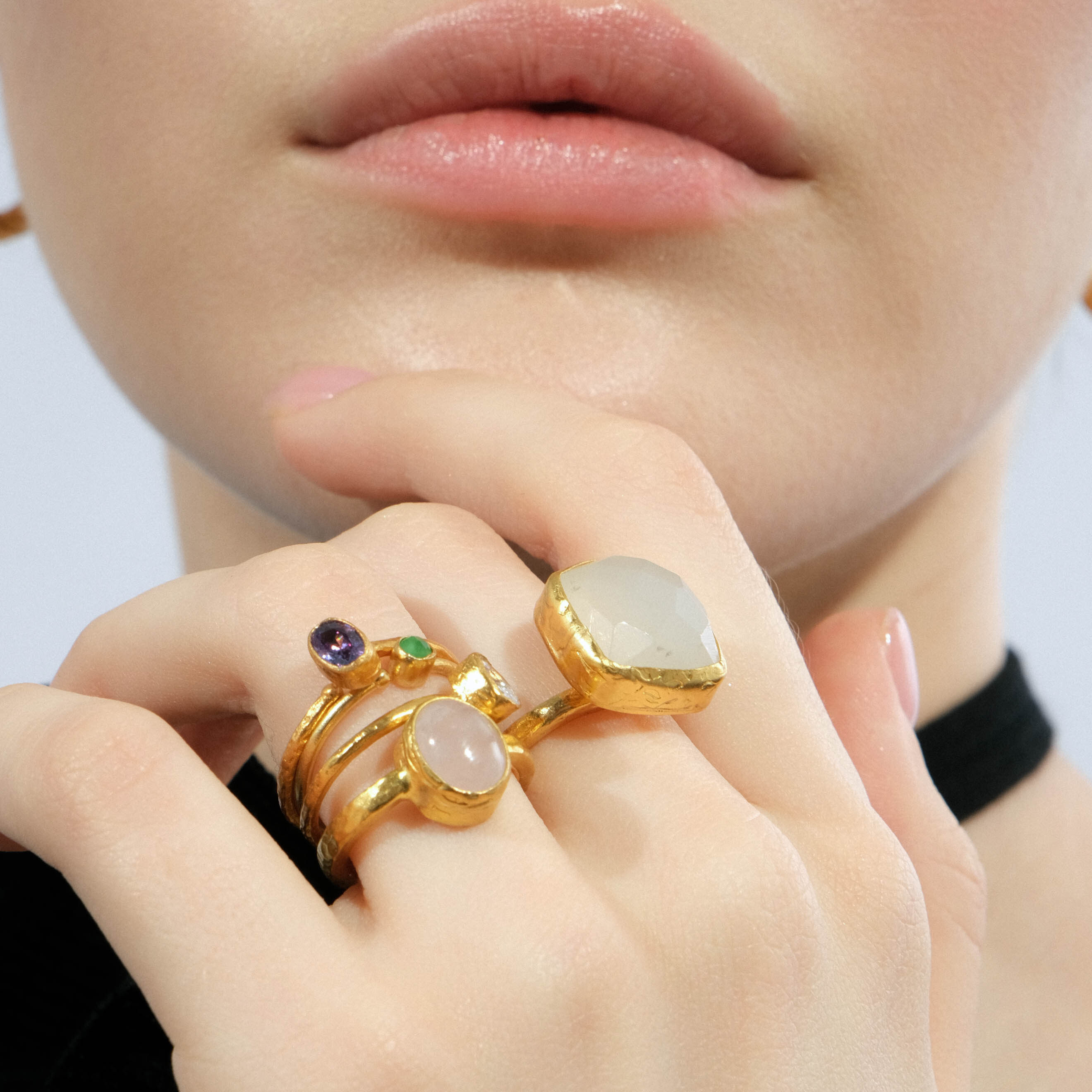 A thin golden ring with a green stone
