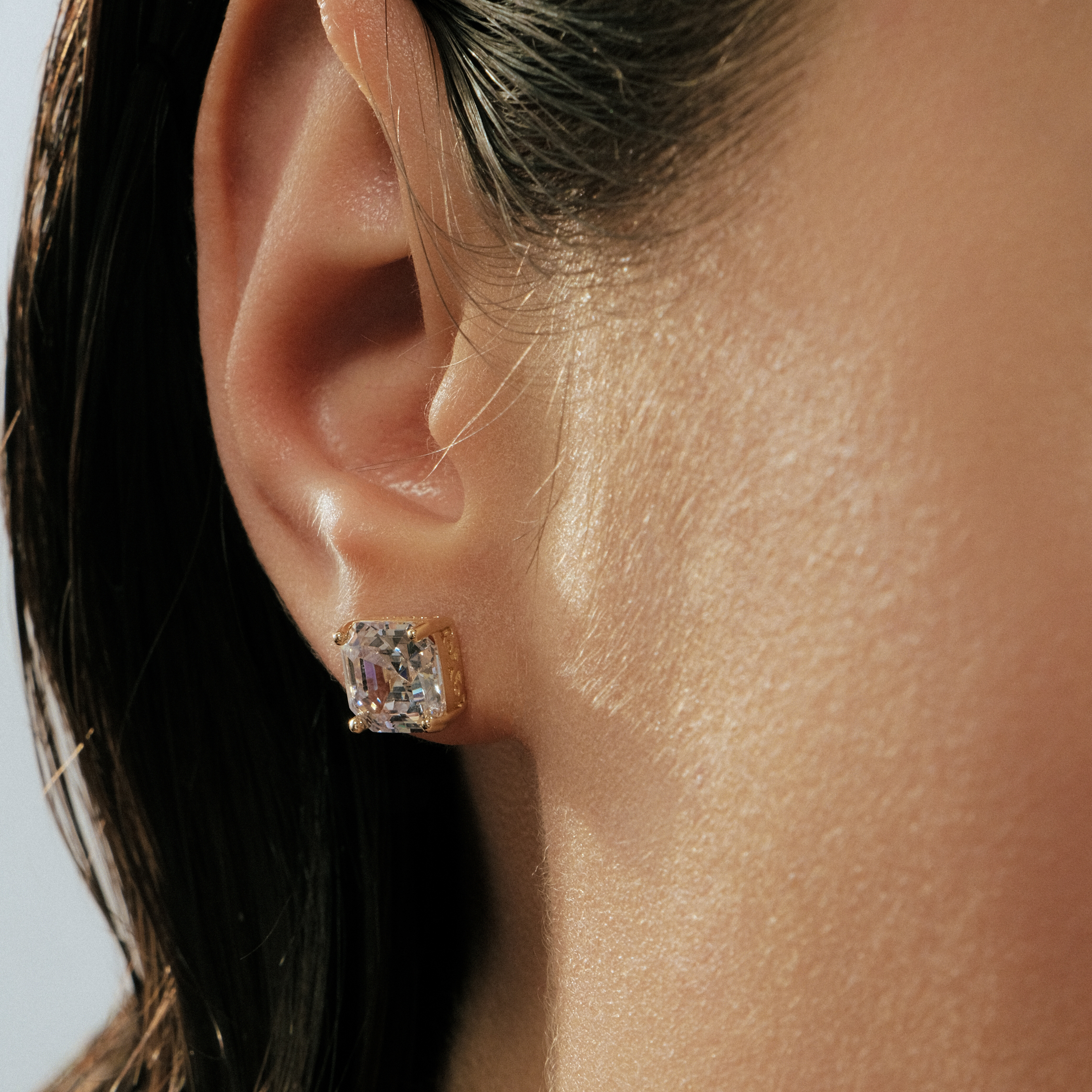 Golden earrings with white crystals