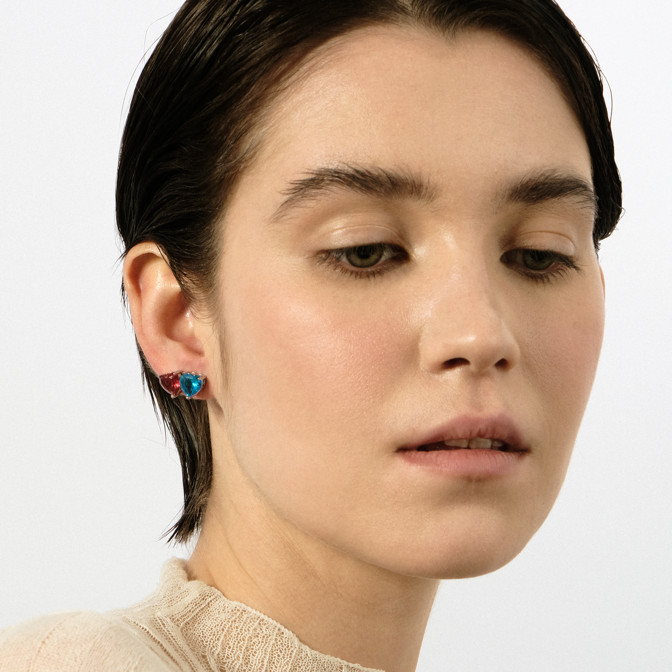 Silver earrings in the shape of a red heart