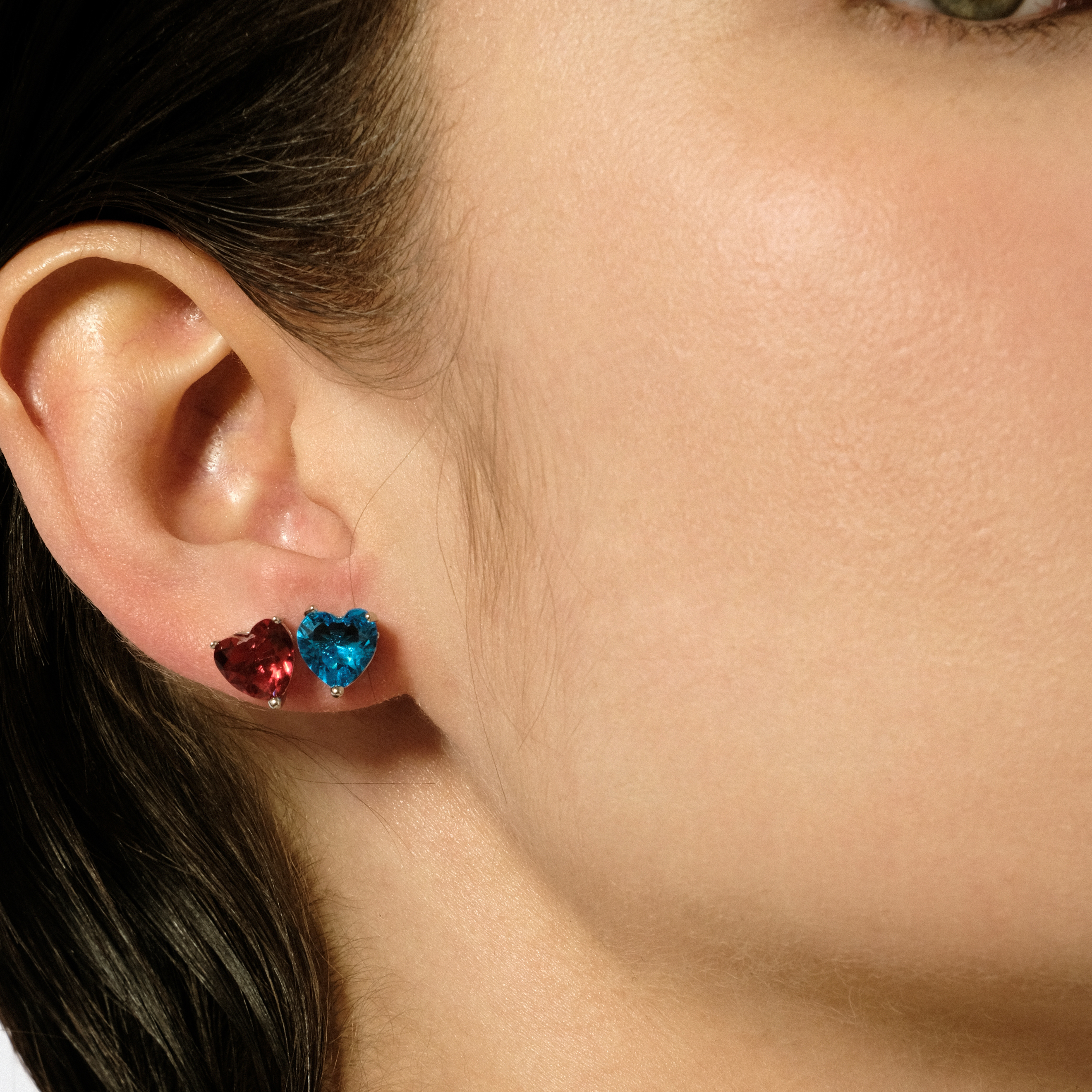 Silver earrings in the shape of a red heart