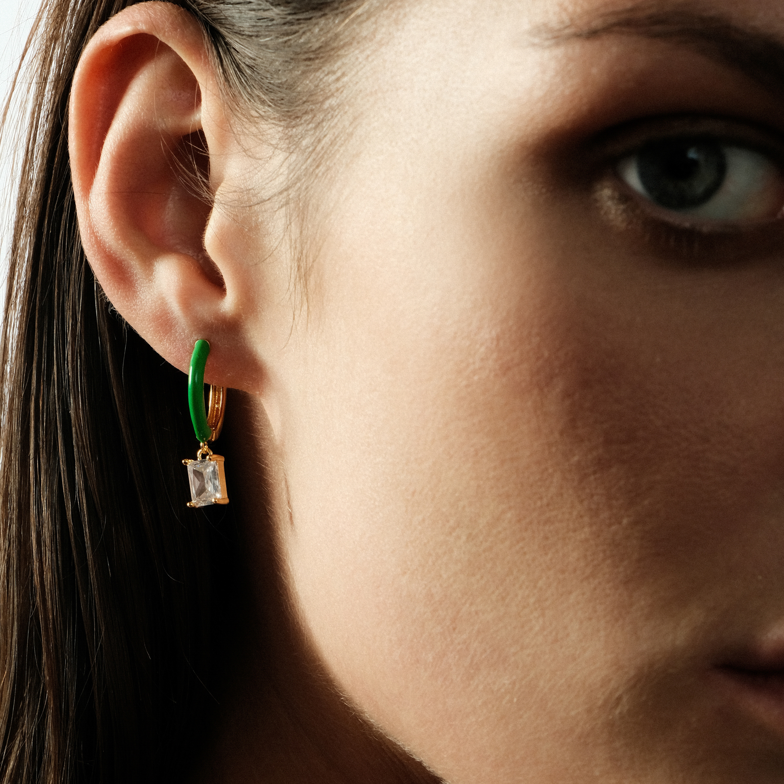 gold-tone enamel earrings with a baguette cut pendant