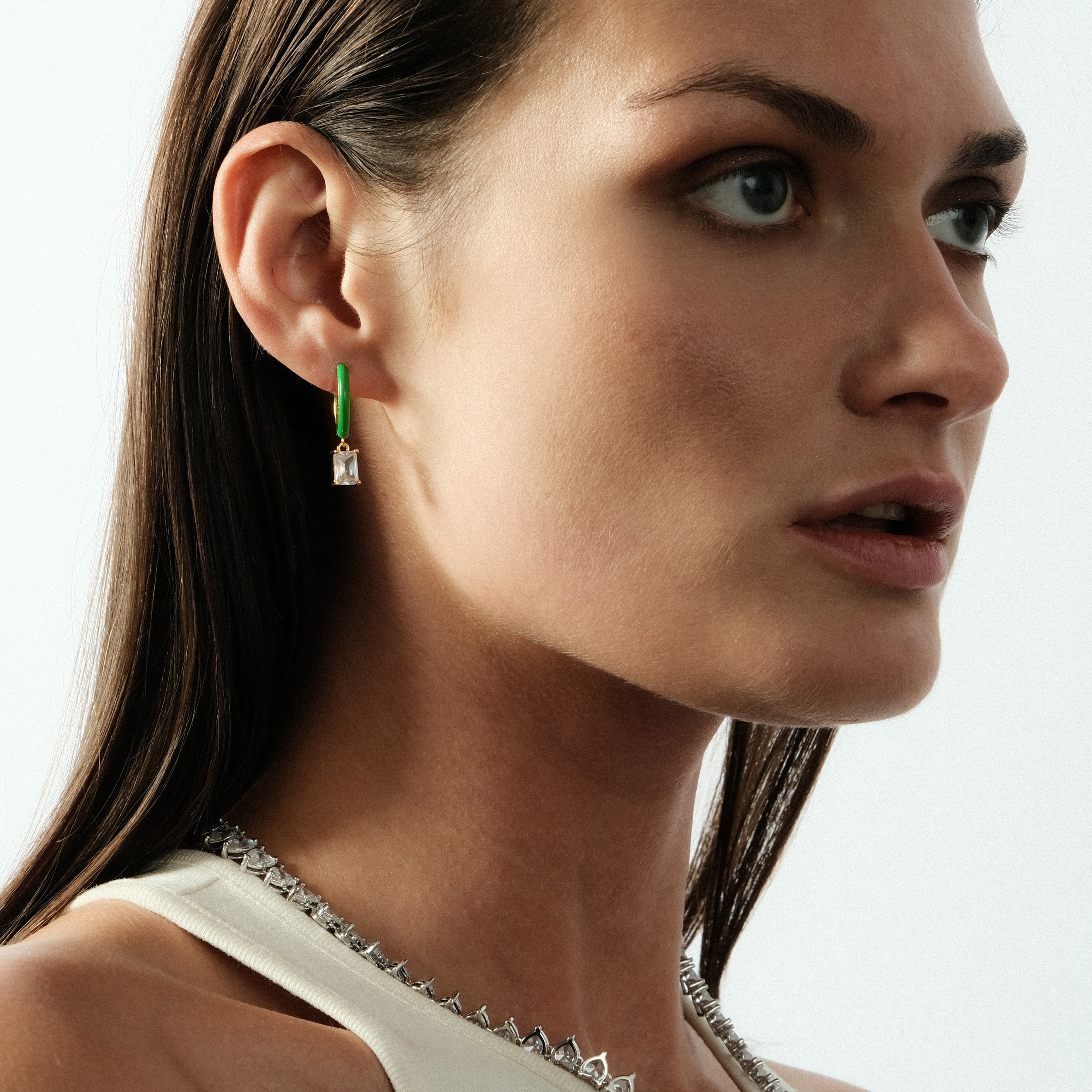 gold-tone enamel earrings with a baguette cut pendant