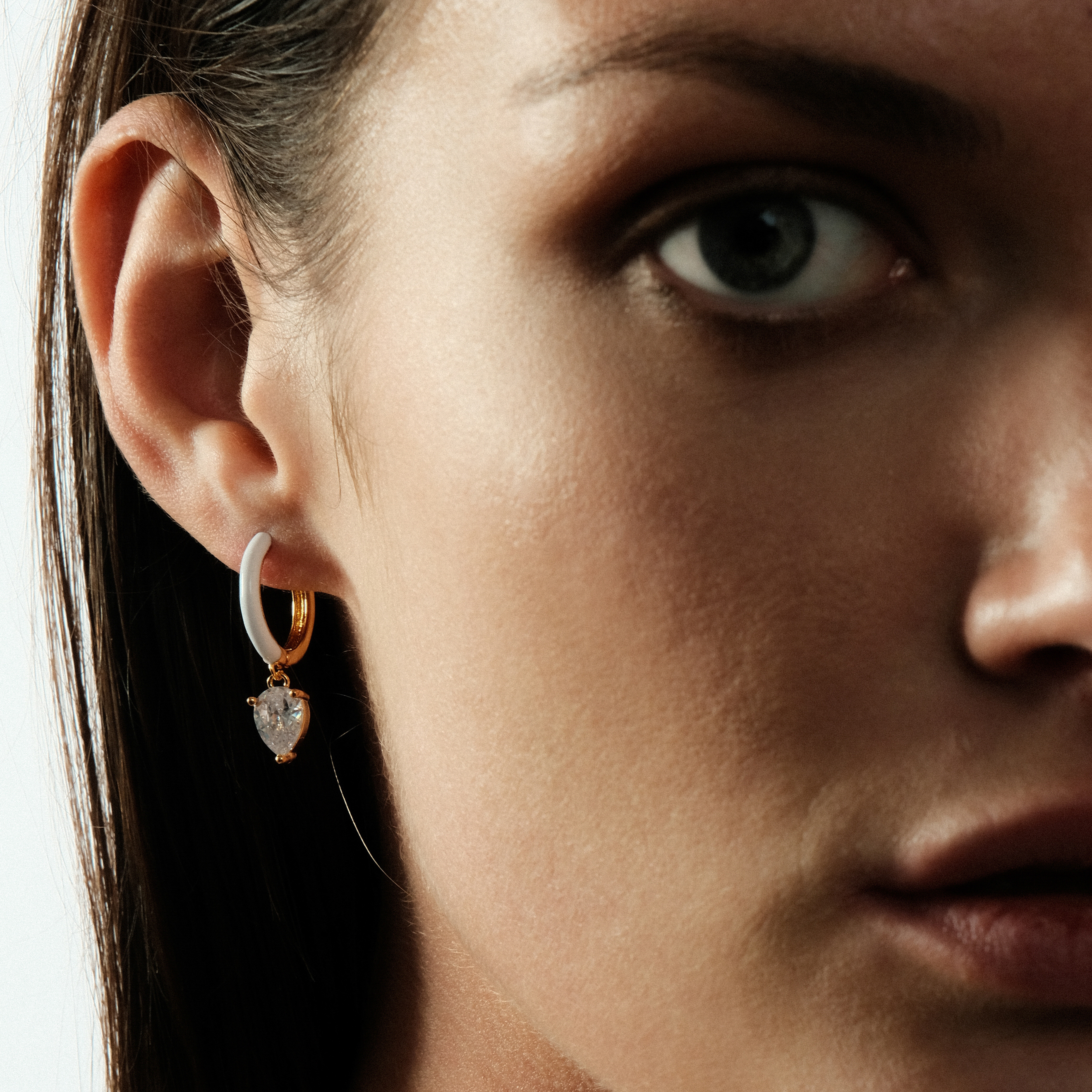 gold-tone enamel earrings with an oval cut pendant