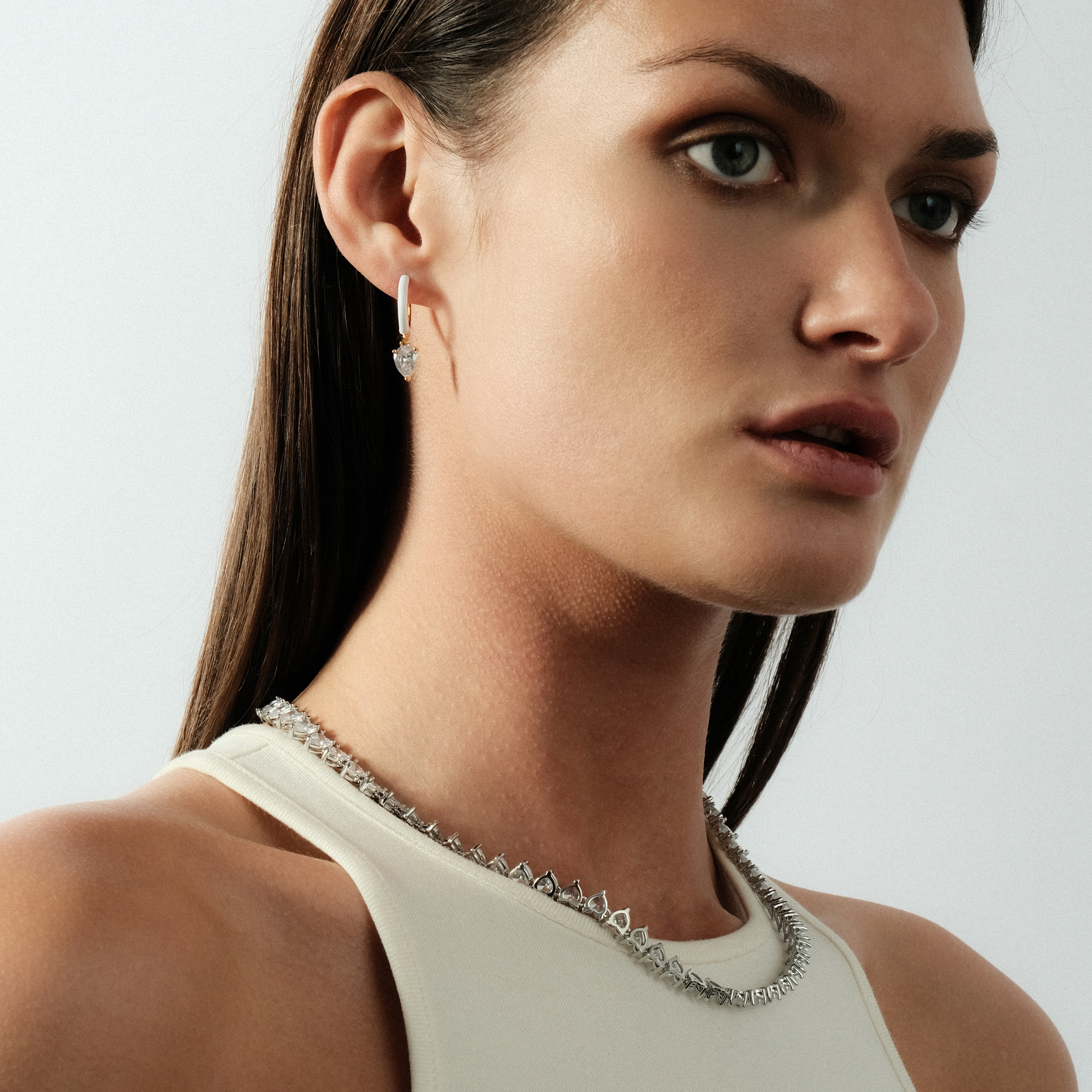 gold-tone enamel earrings with an oval cut pendant