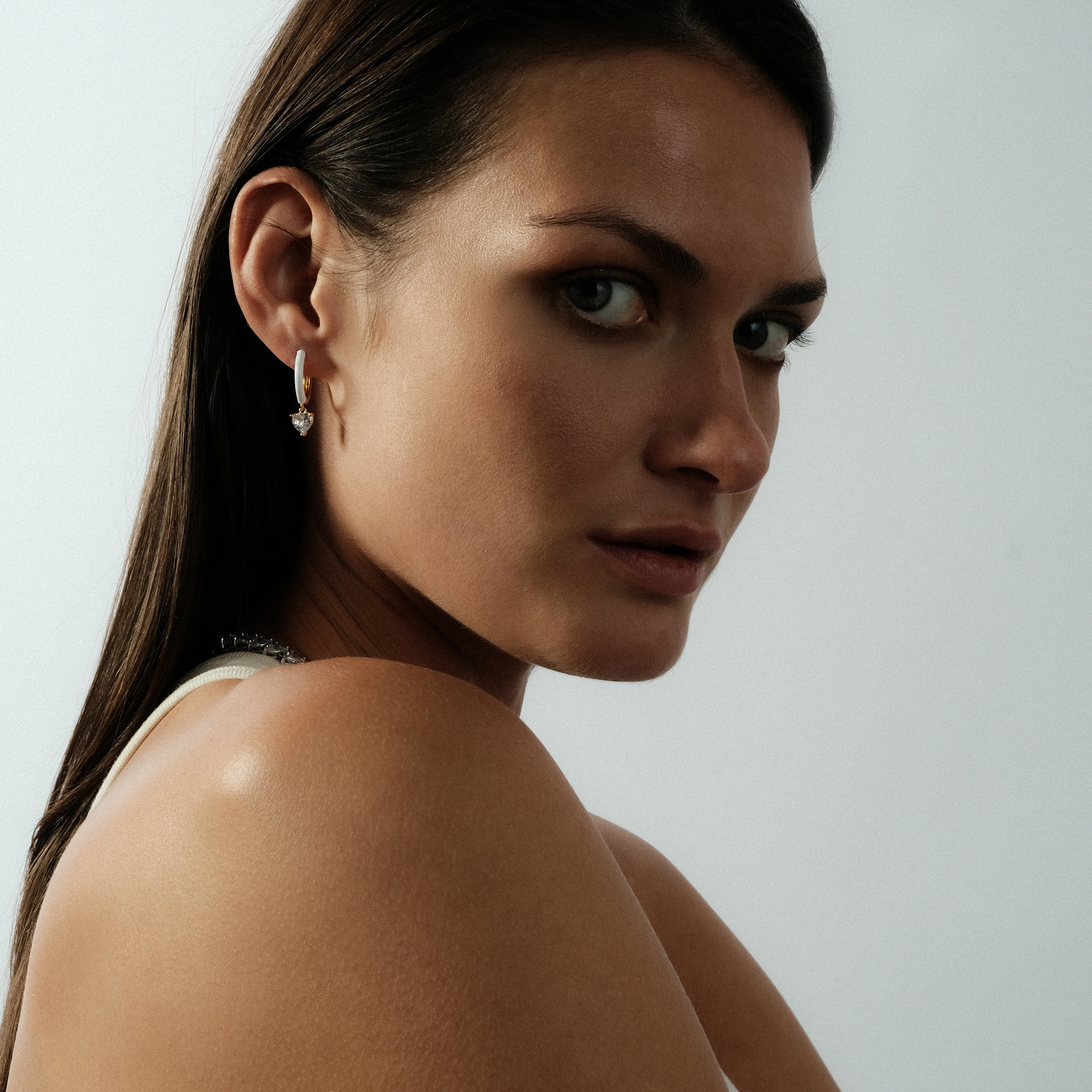 gold-tone enamel earrings with a heart pendant