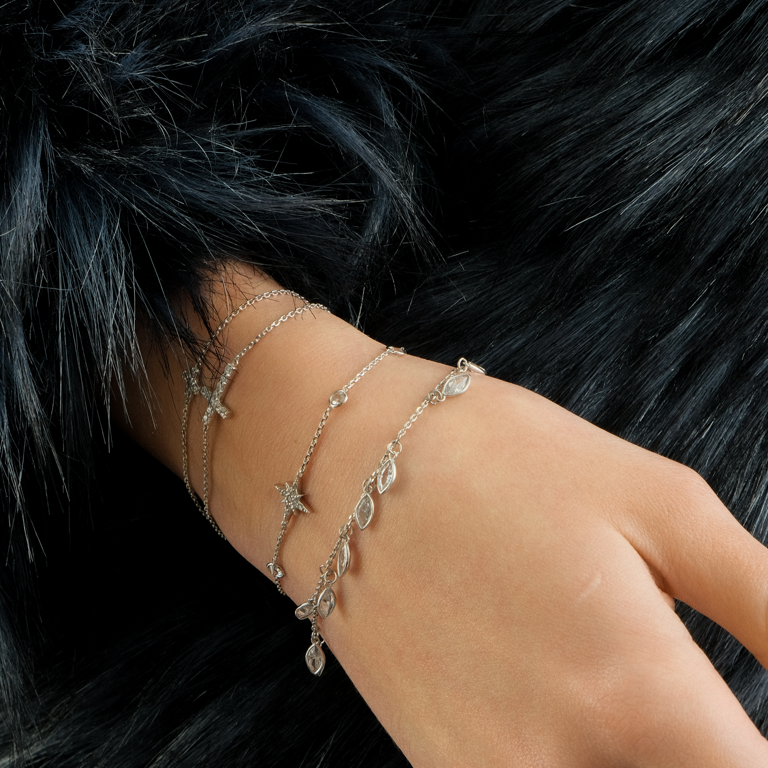 Bracelet with a cross with white gold stones