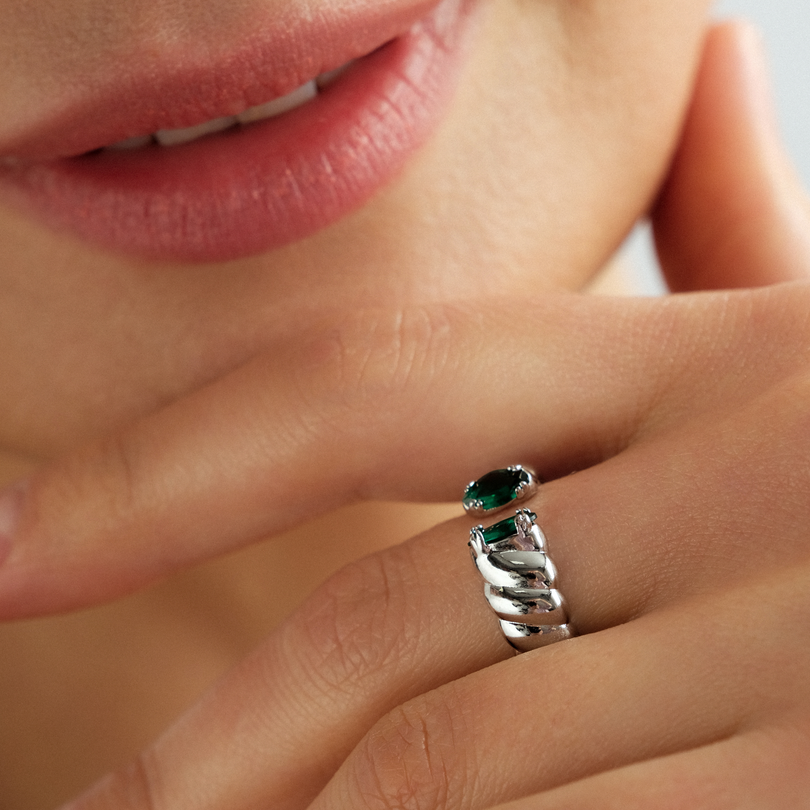 Silver twisted ring with green marquis cut crystals