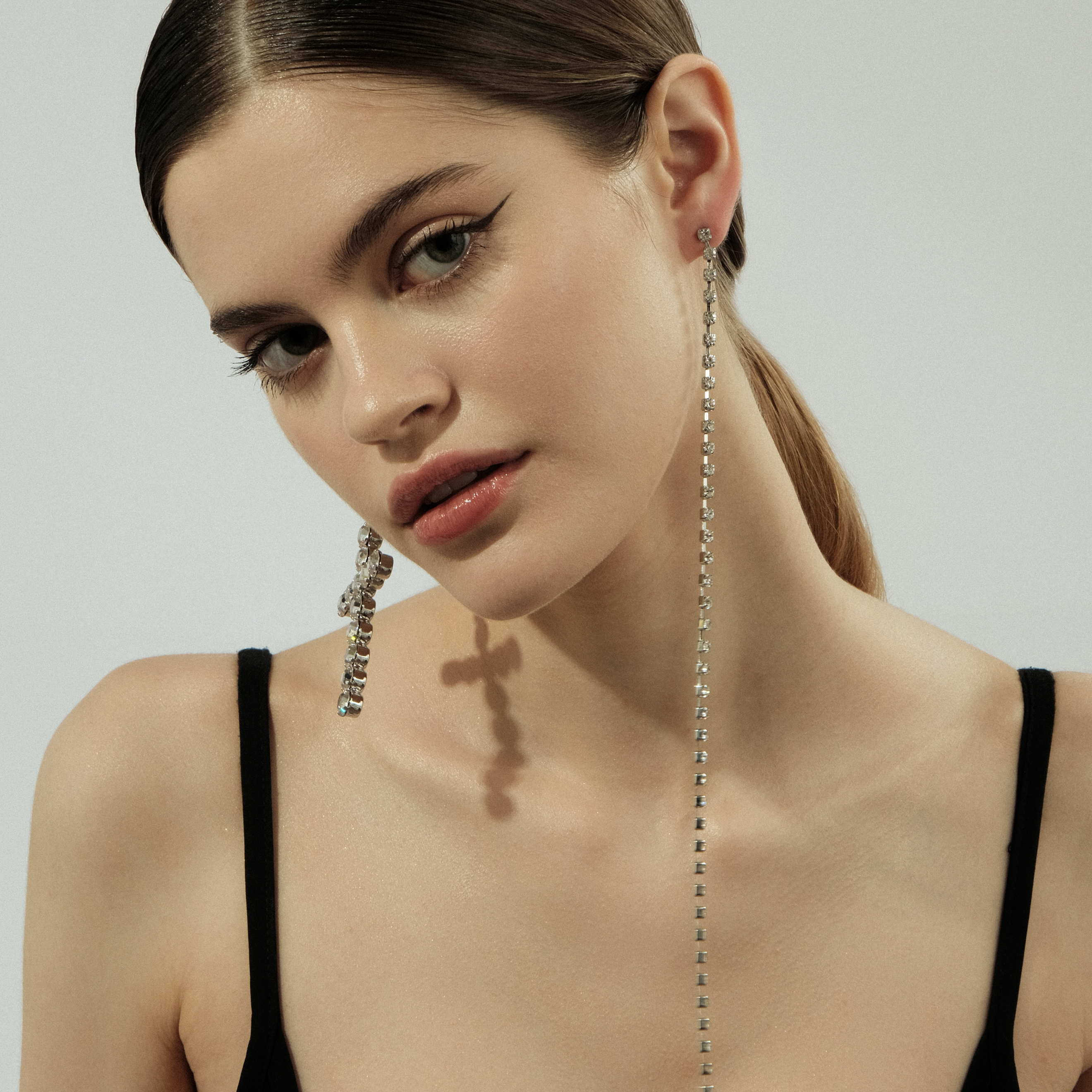 Asymmetric  earrings with a cross and crystals