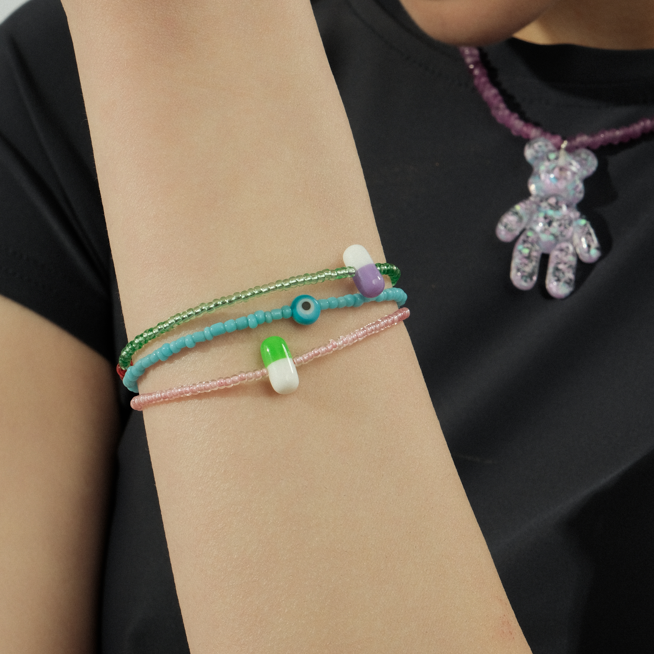 Pink bracelet with green pill