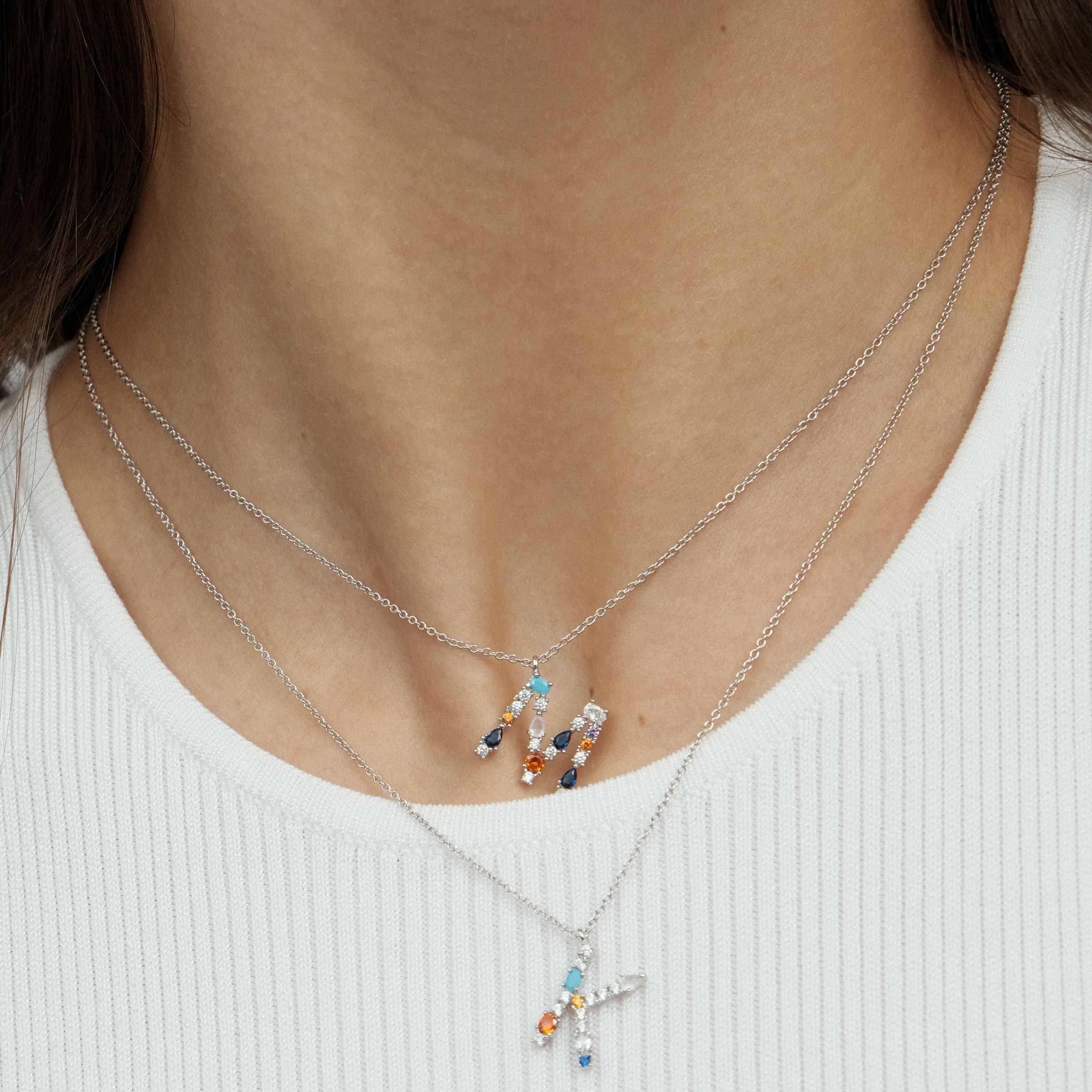pendant with the letter M made of colored crystals