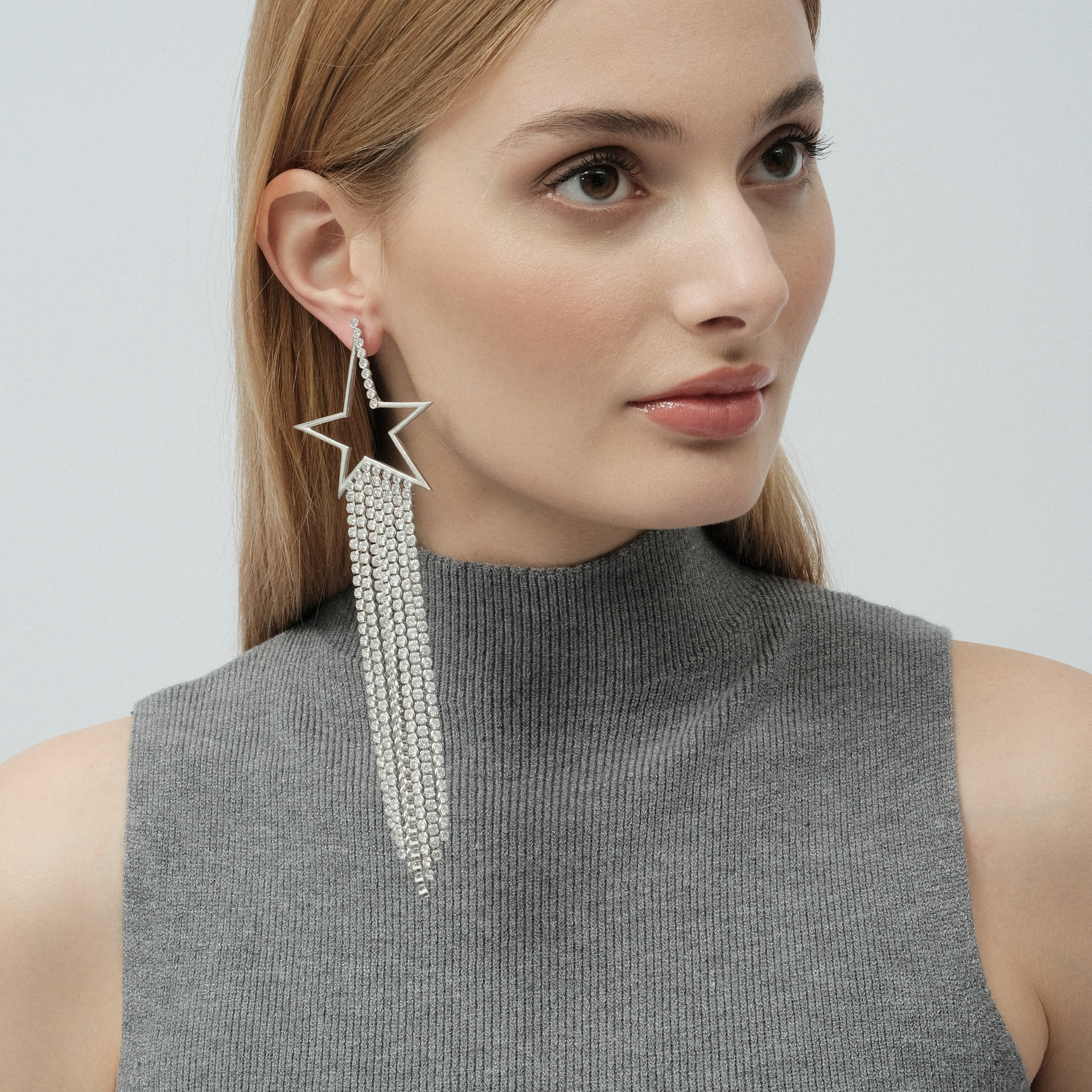 Asymmetric star earrings with a cascade of crystals