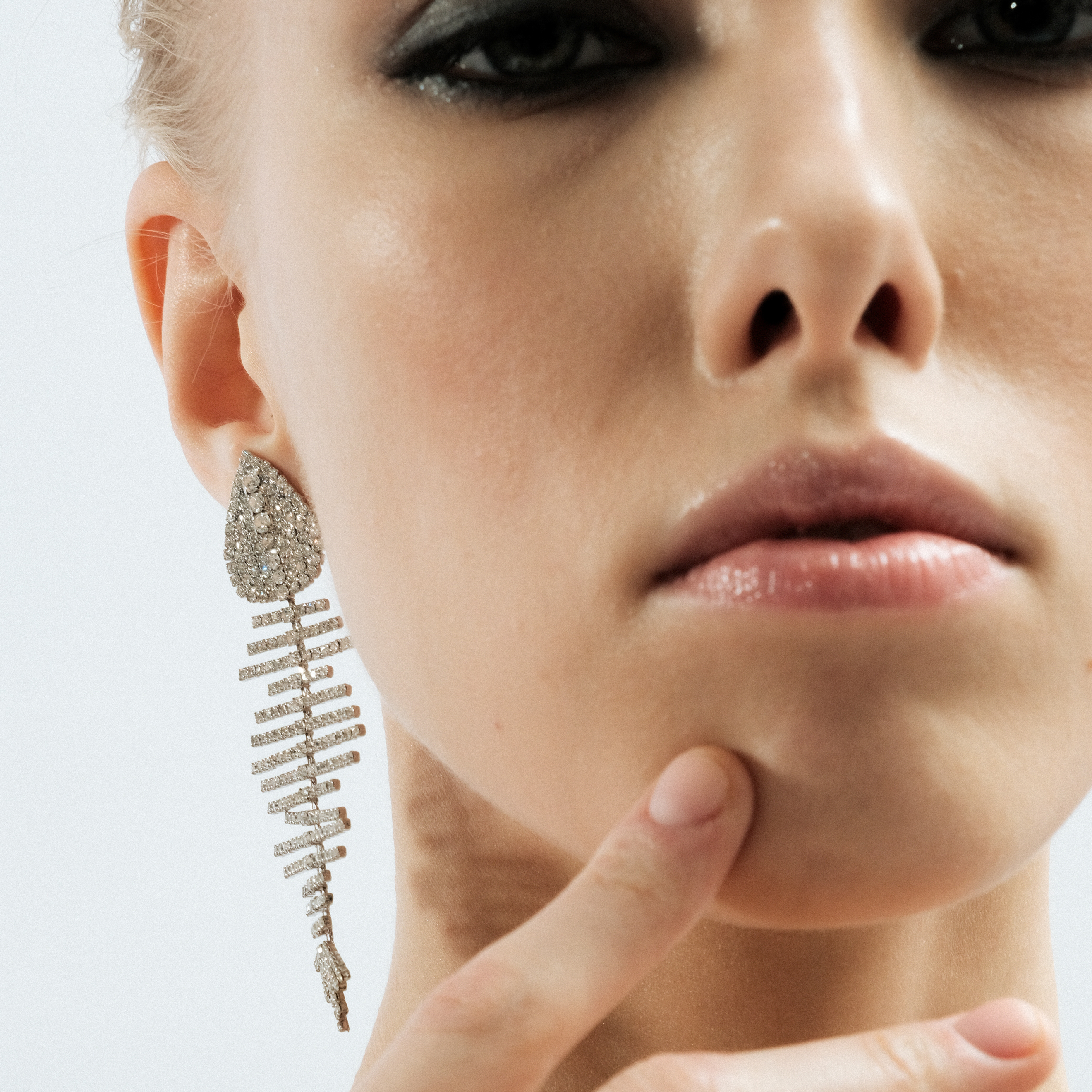 Silver fish earrings with white crystals