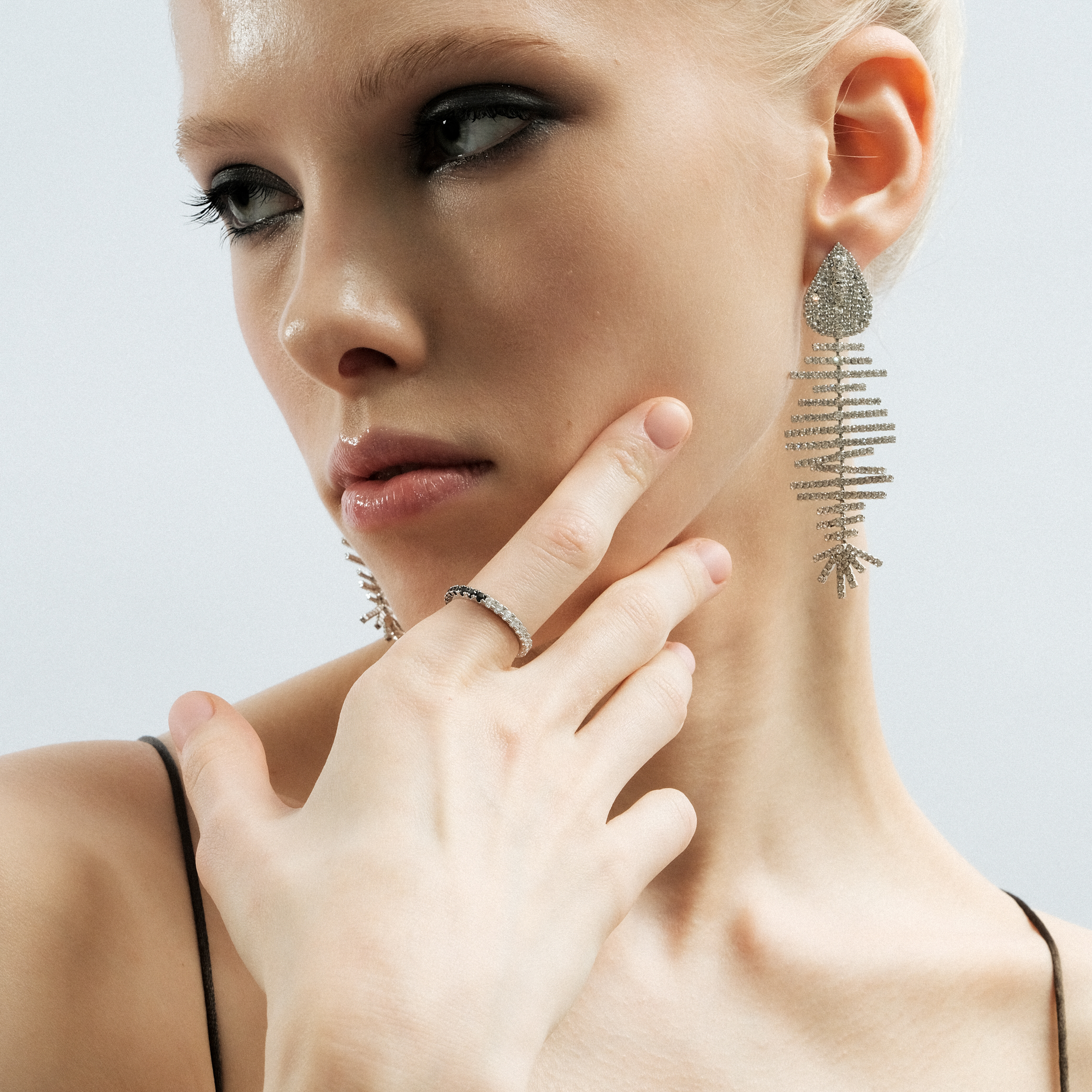 Silver fish earrings with white crystals