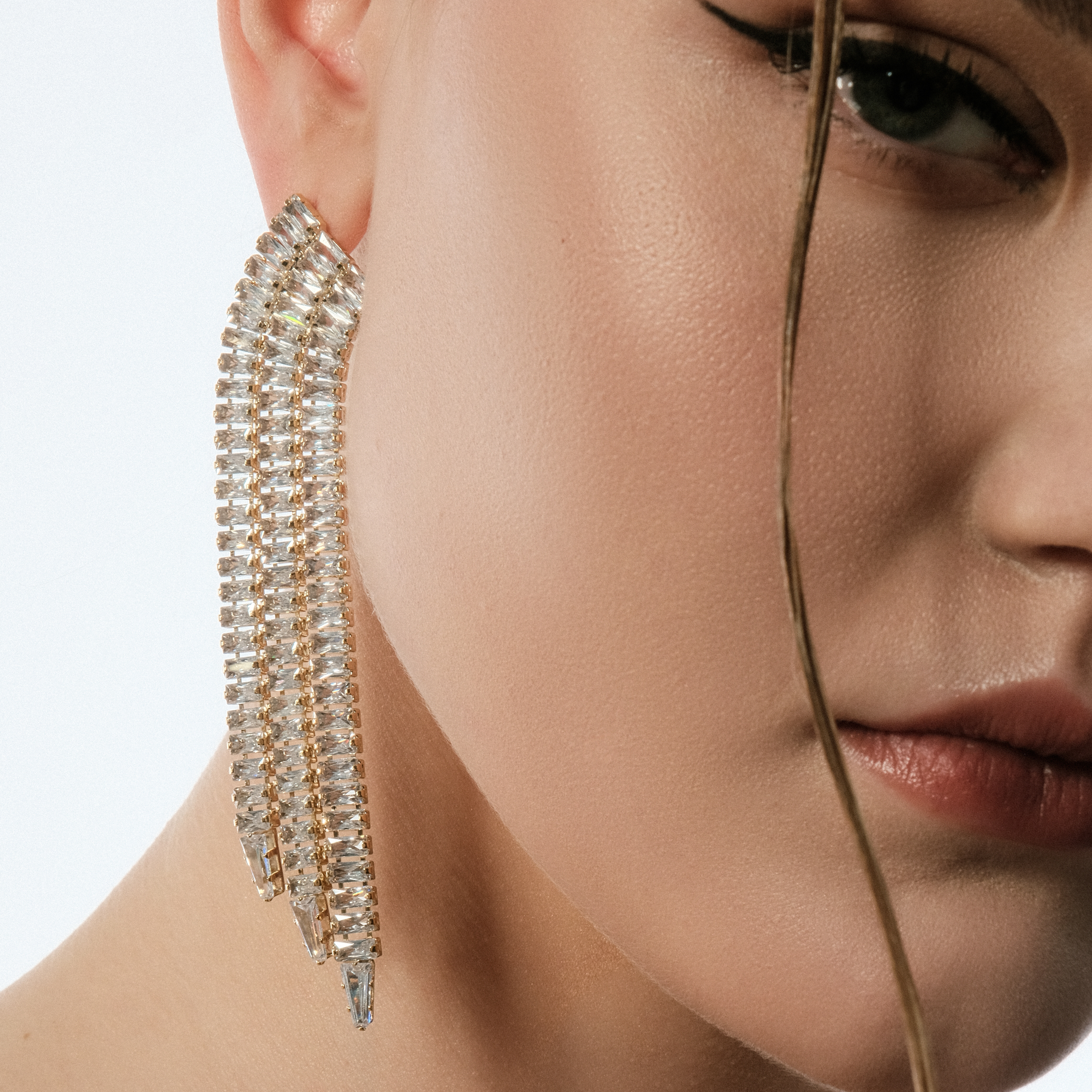 Golden earrings with long crystal track pendants