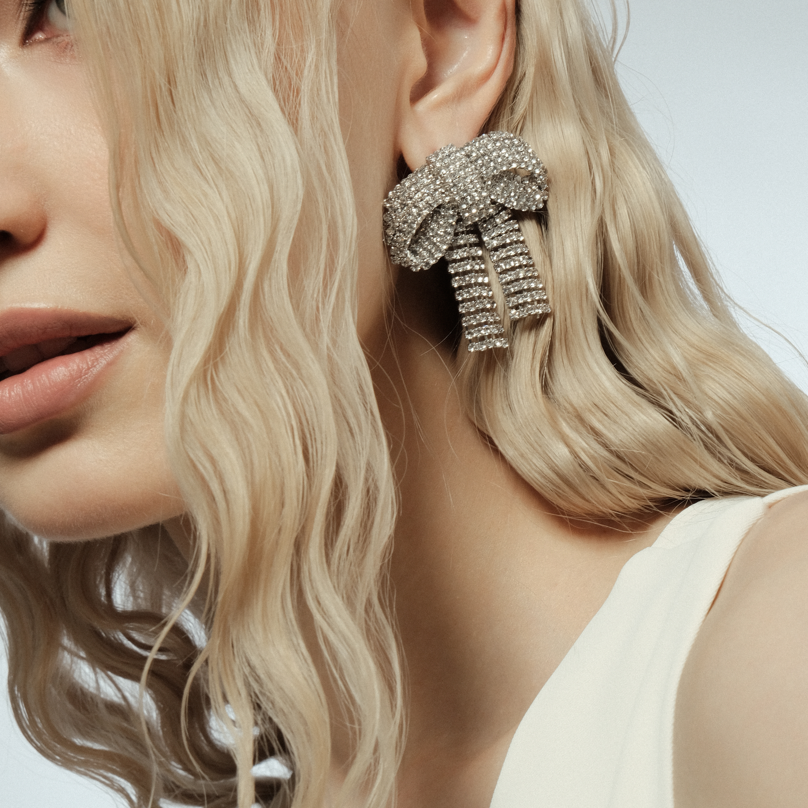 Silver earrings with crystals in the form of bows