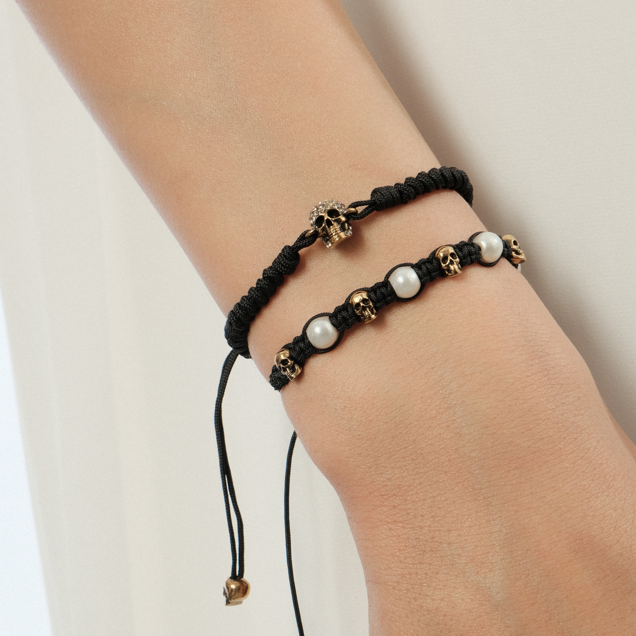 Braided bracelet with skulls and pearl beads