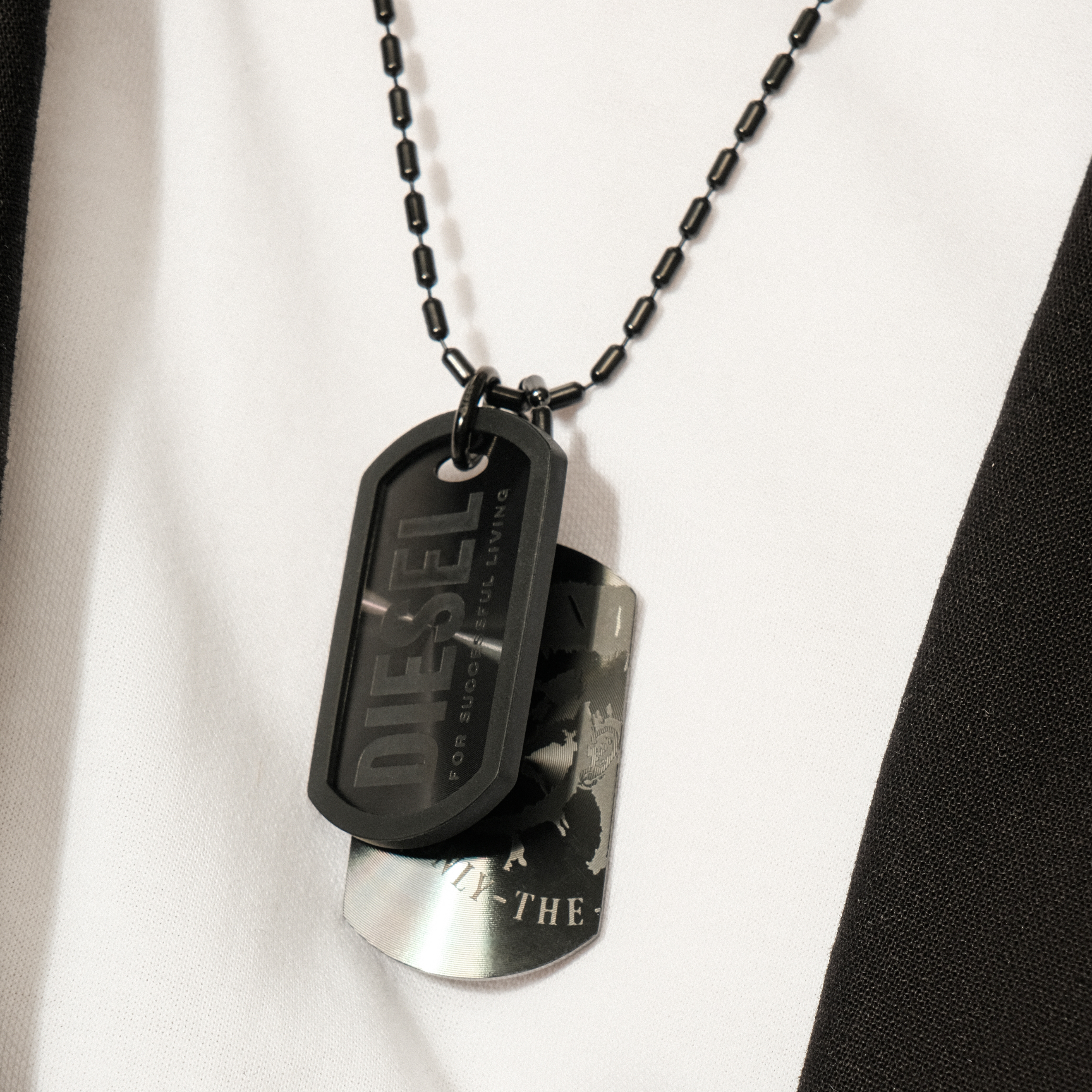 Double black pendant token on a black chain