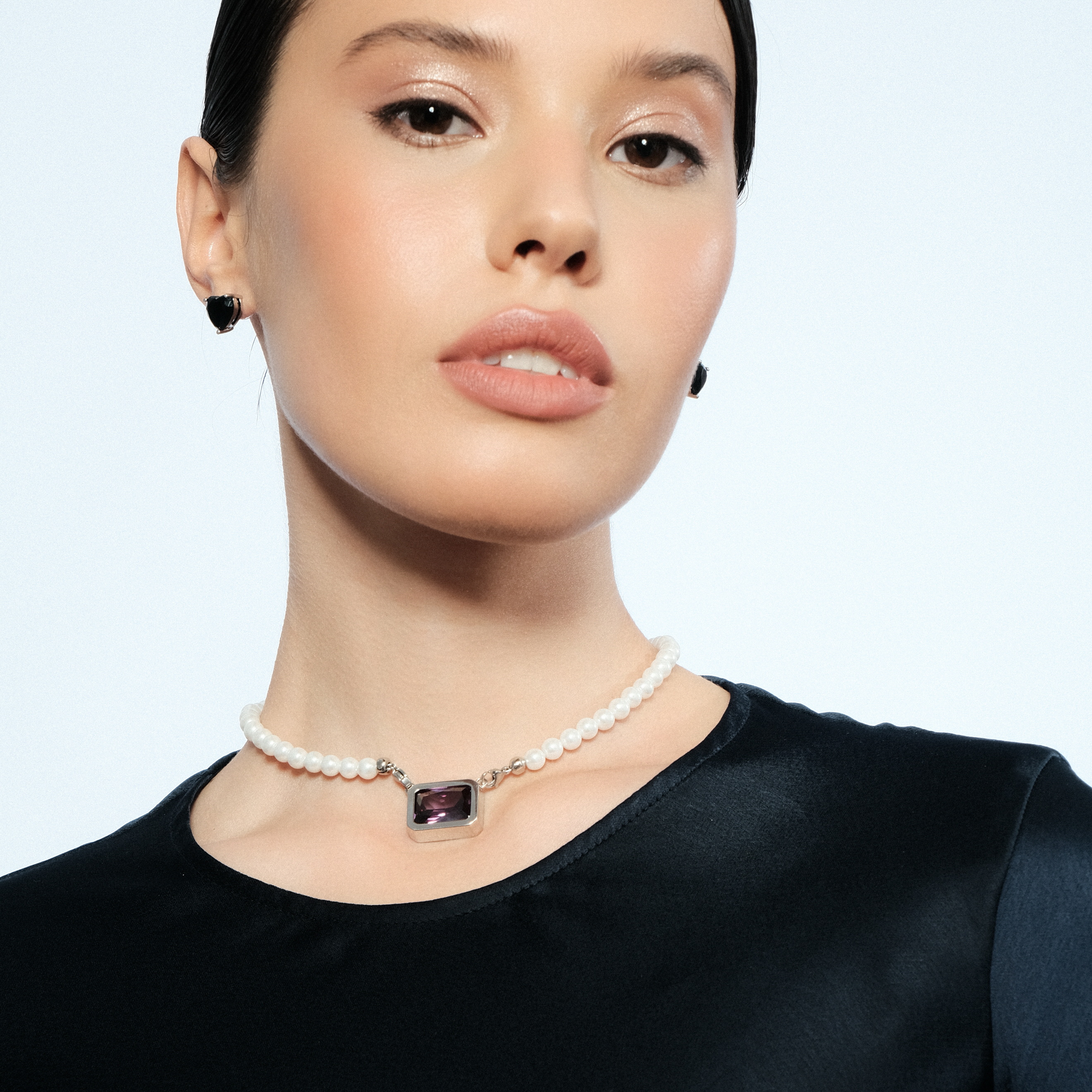 Silver earrings in the shape of a black heart