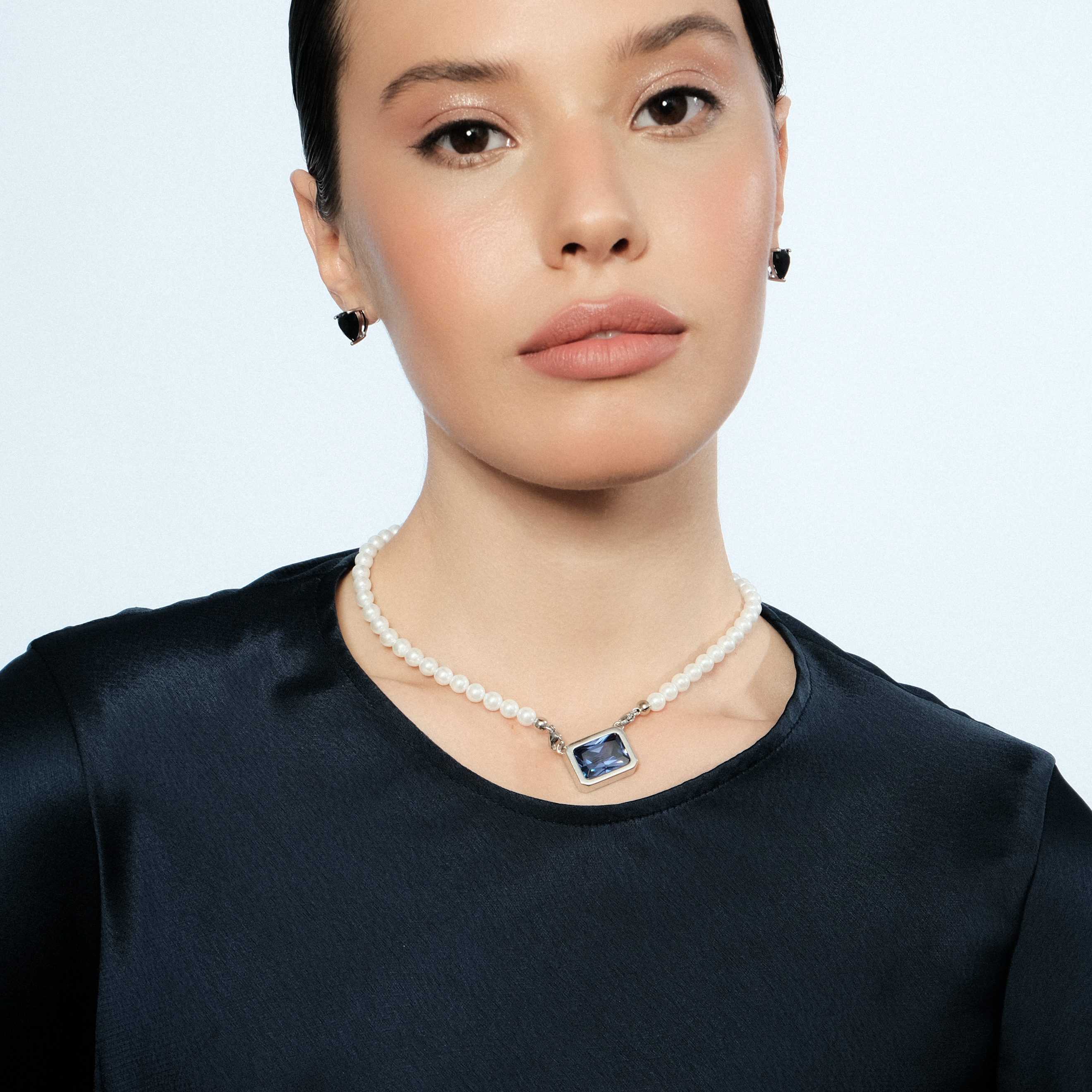 Silver earrings in the shape of a black heart