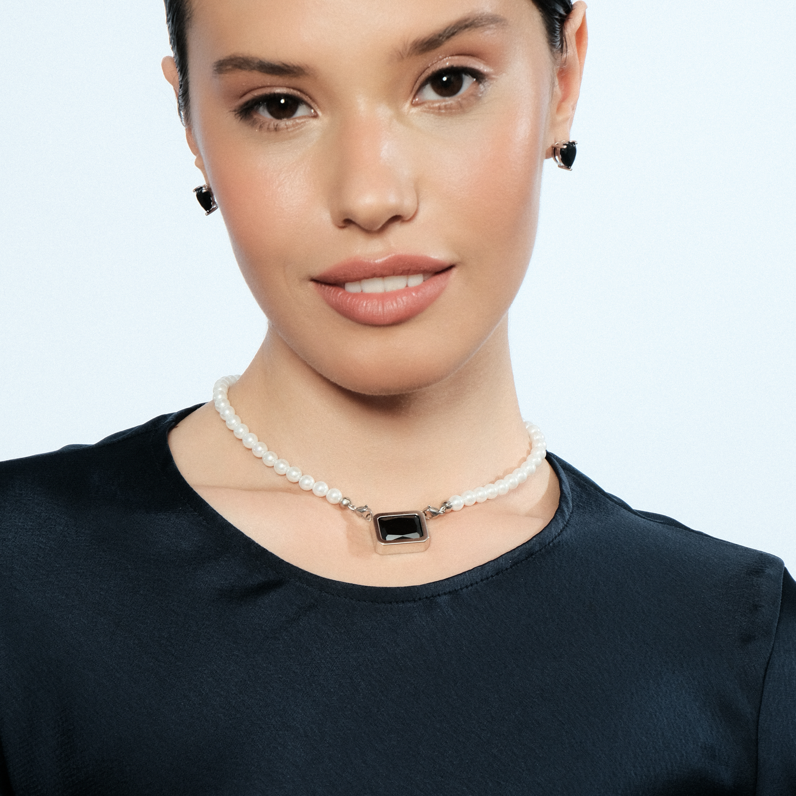 Silver earrings in the shape of a black heart
