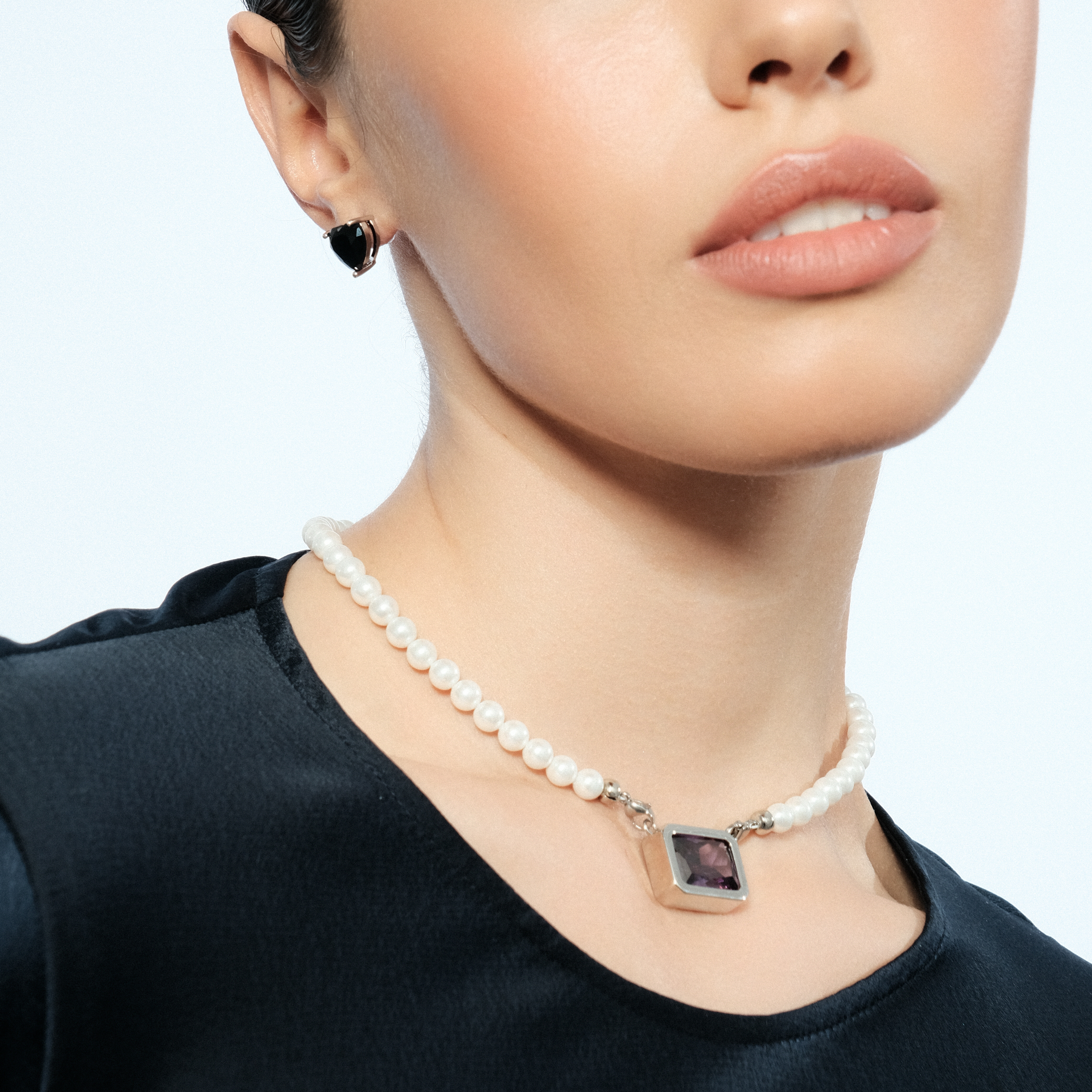 Silver earrings in the shape of a black heart