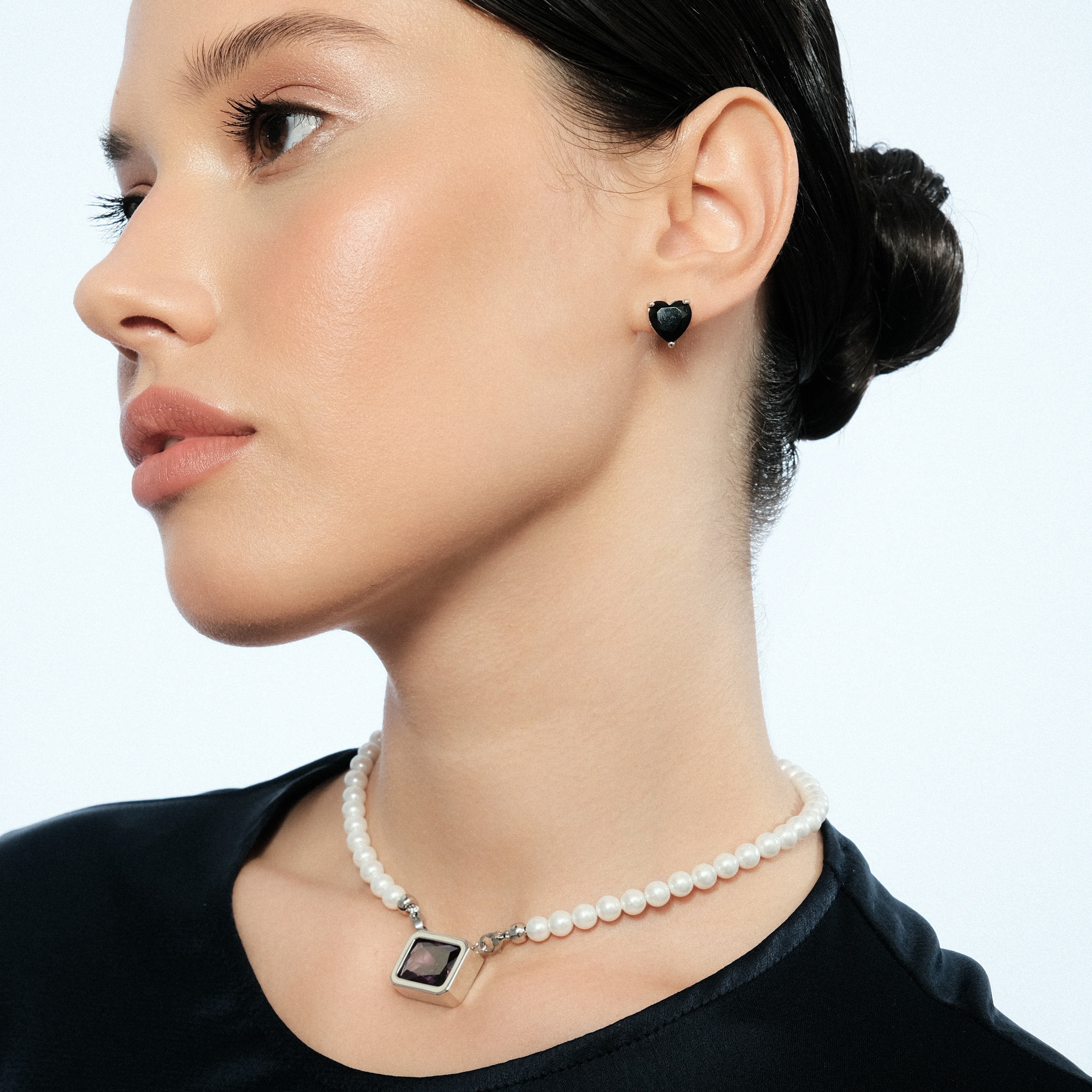 Silver earrings in the shape of a black heart