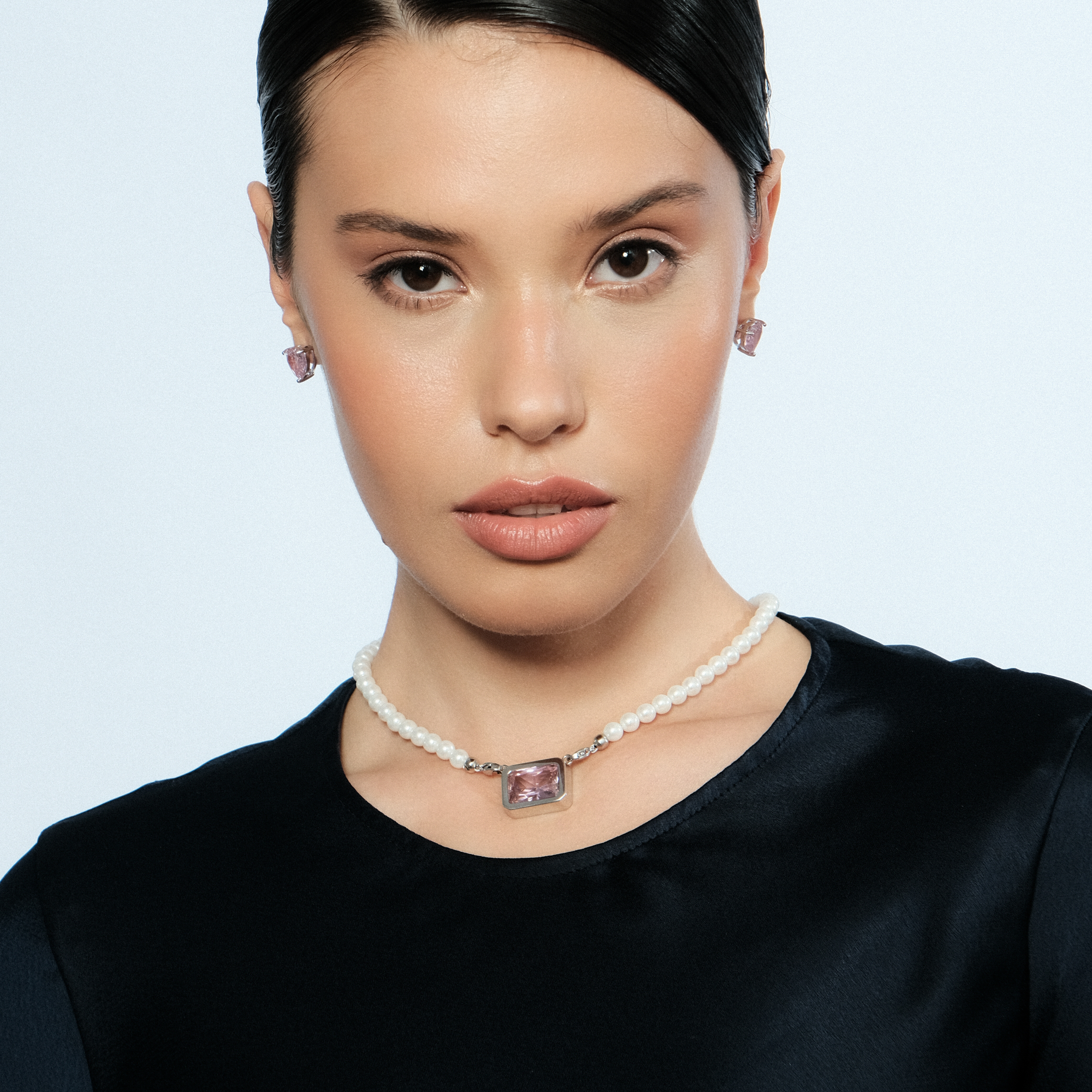 Silver earrings in the shape of a pink heart