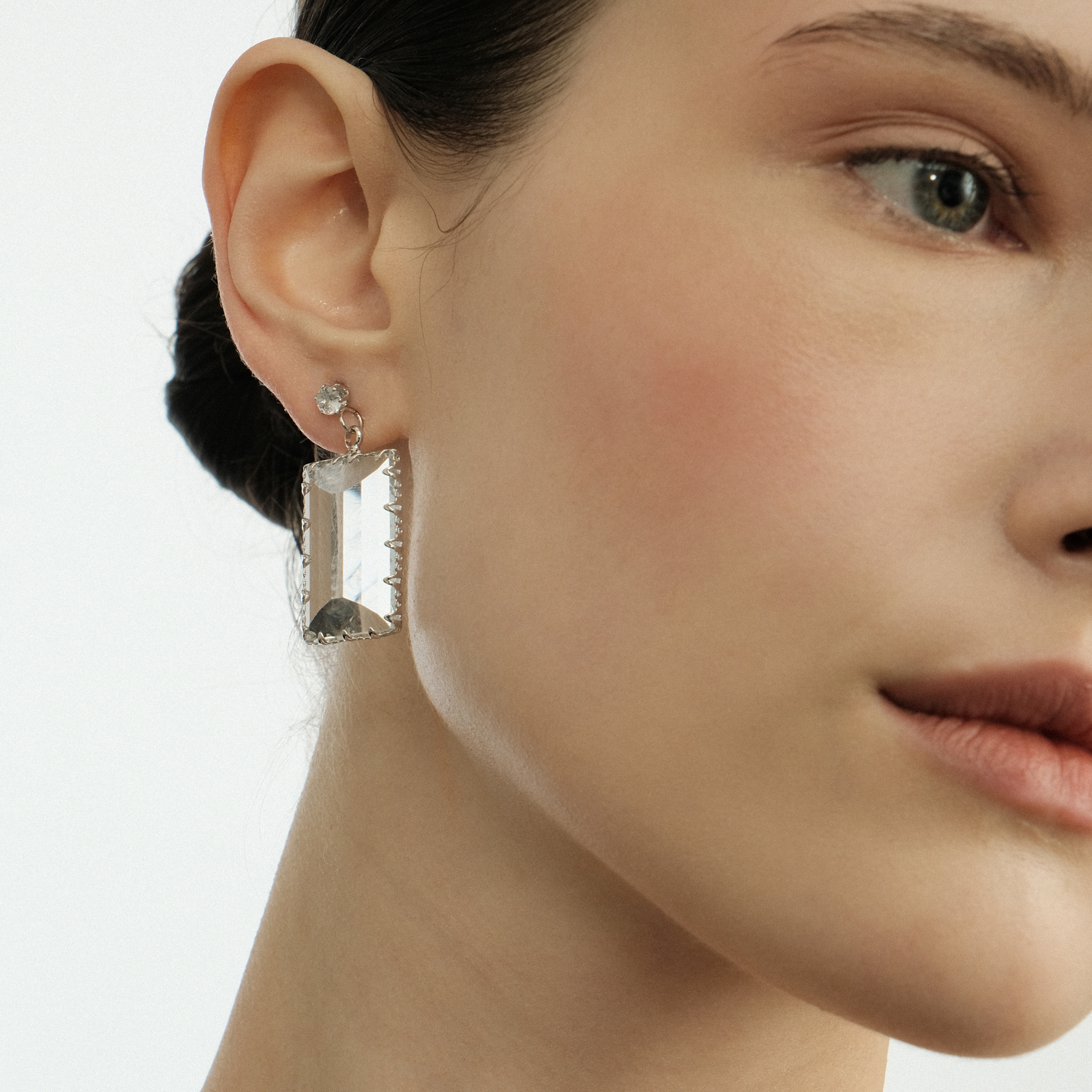 Earrings with a large transparent rectangular crystal