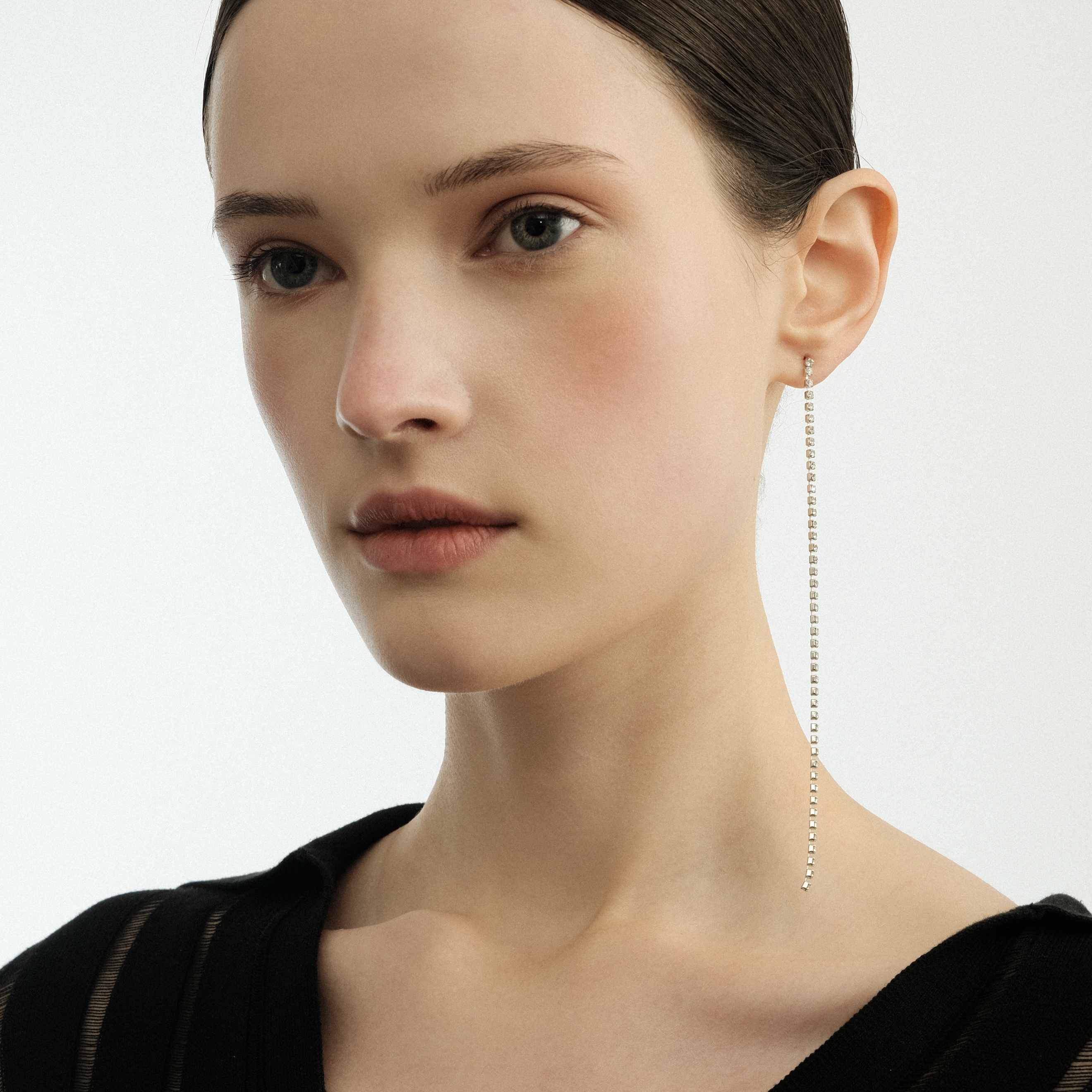 Thin silver-tone earrings with crystals