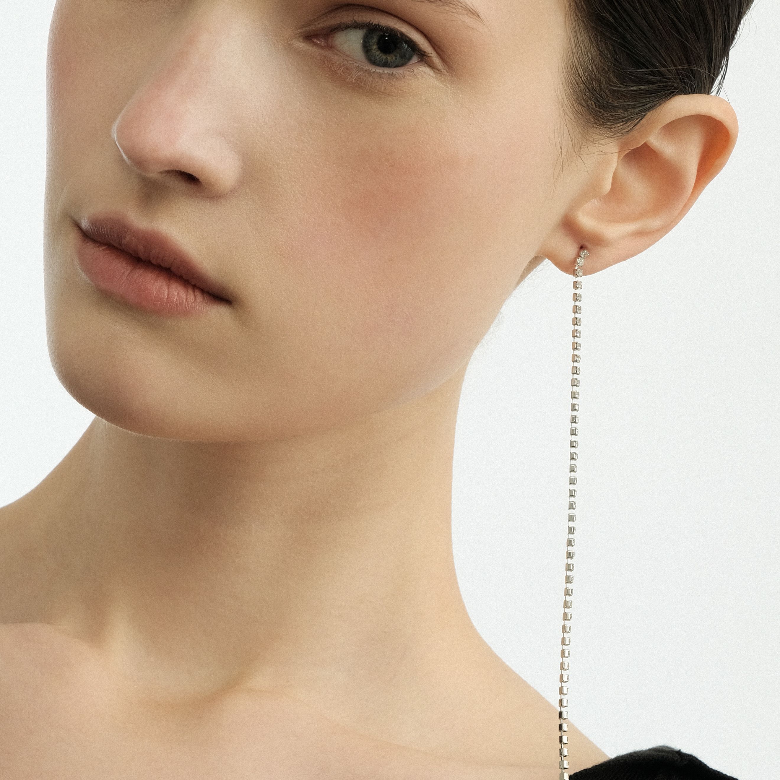 Thin silver-tone earrings with crystals