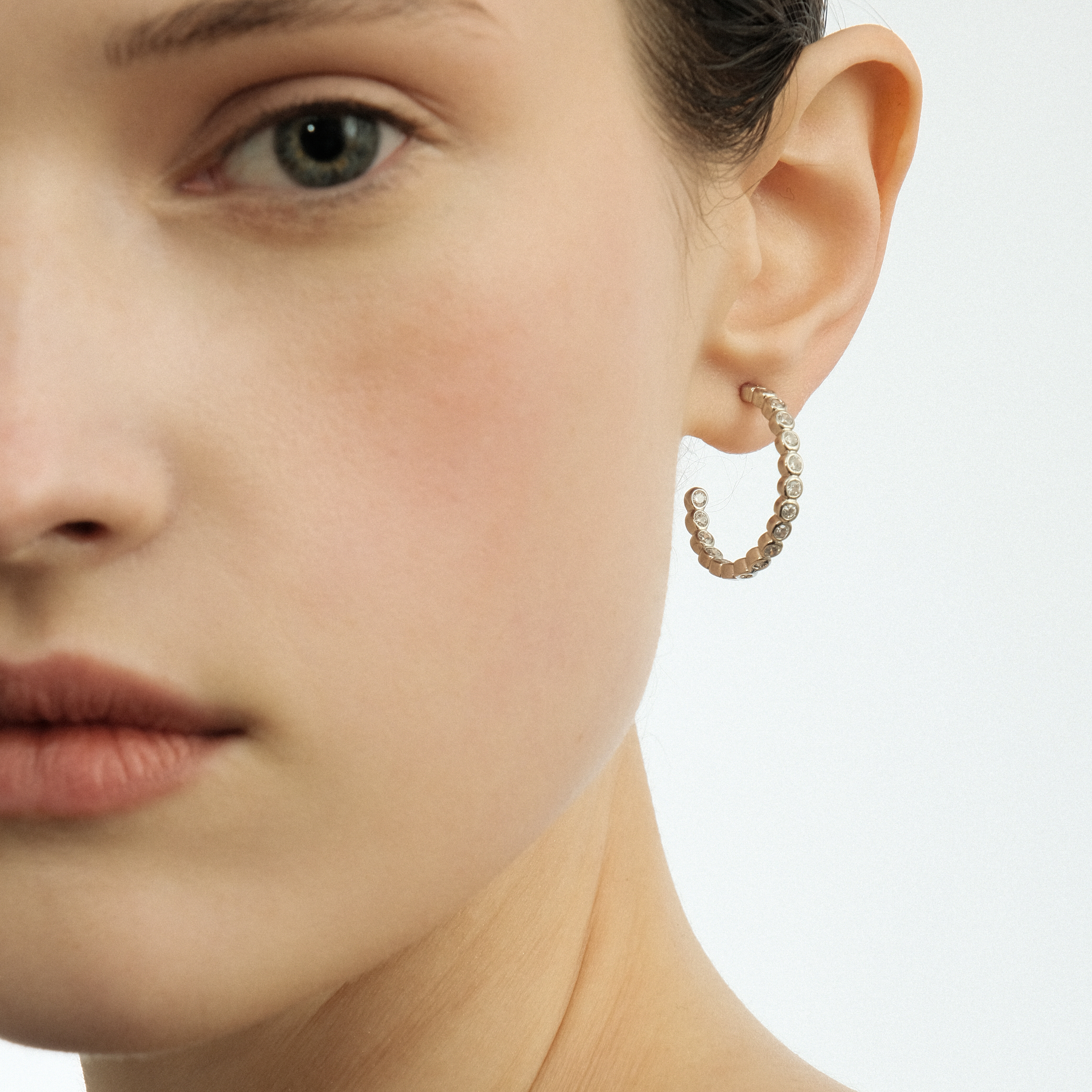 Silver hoop earrings made of round crystals