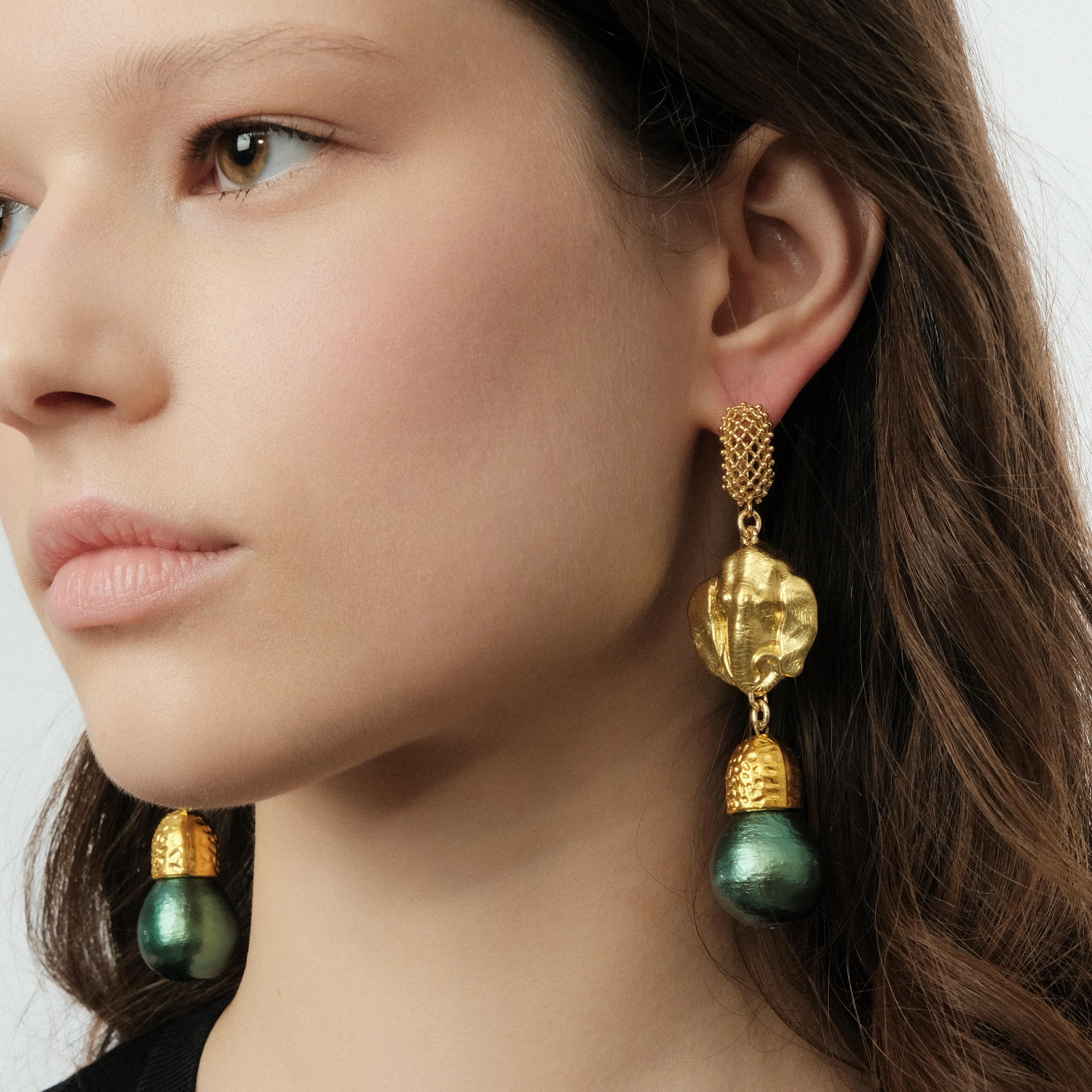 Golden elephant head earrings and green pearls