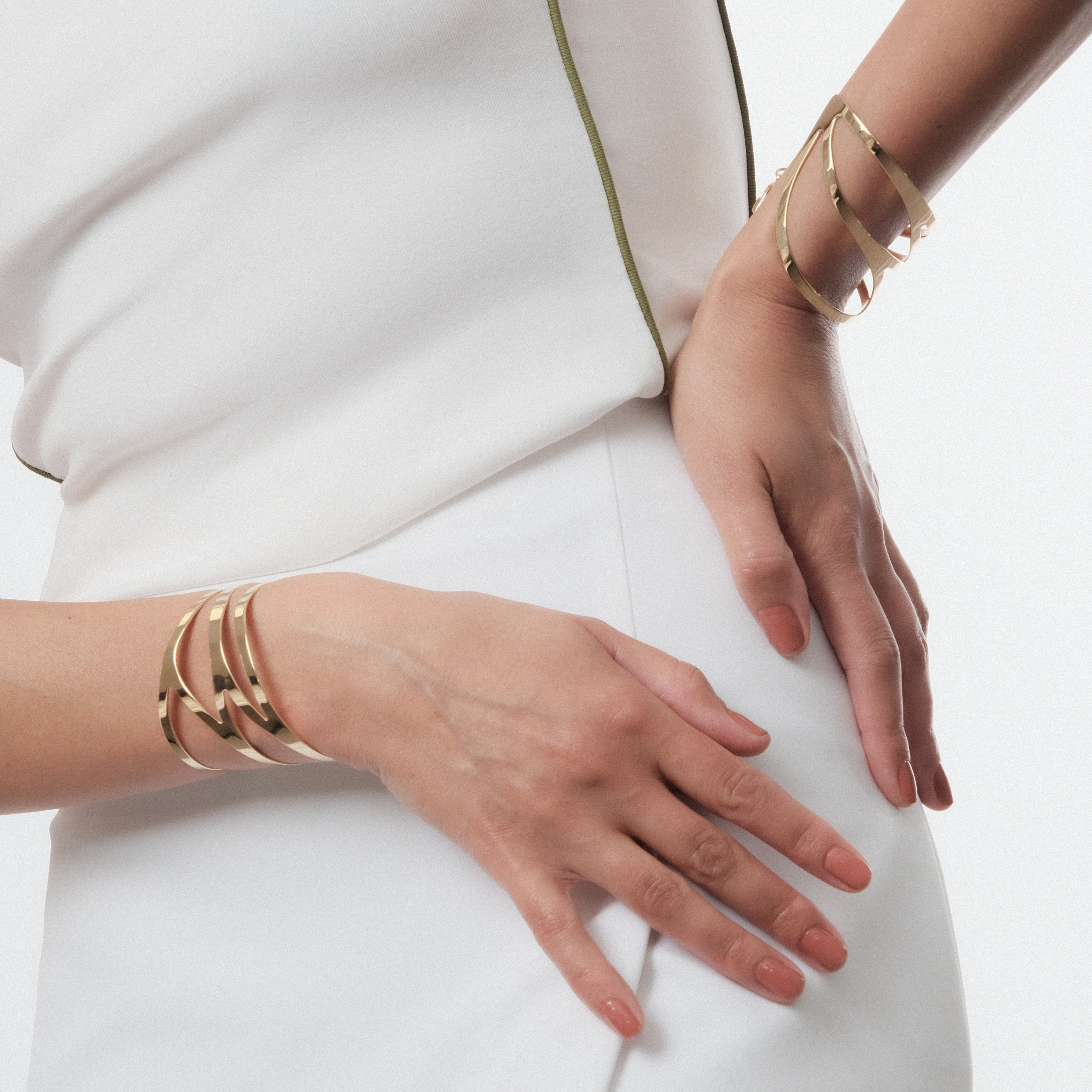 A pair of symmetrical adjustable gold-plated dragonfly bracelets on the wrist