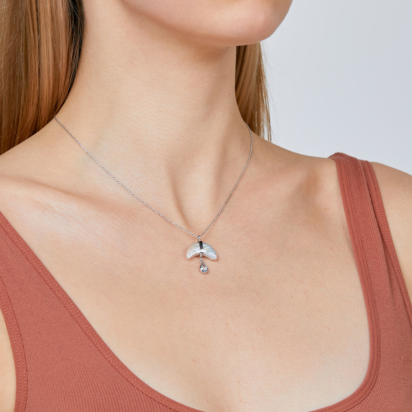 Necklace made of silver with crescent pearls and topaz