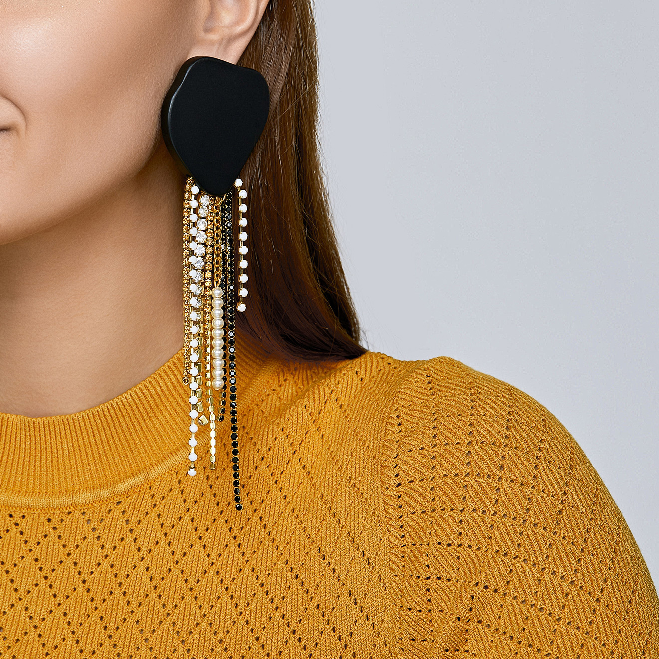 Black square earrings made of wood with cascading pendants made of colored crystals and pearls