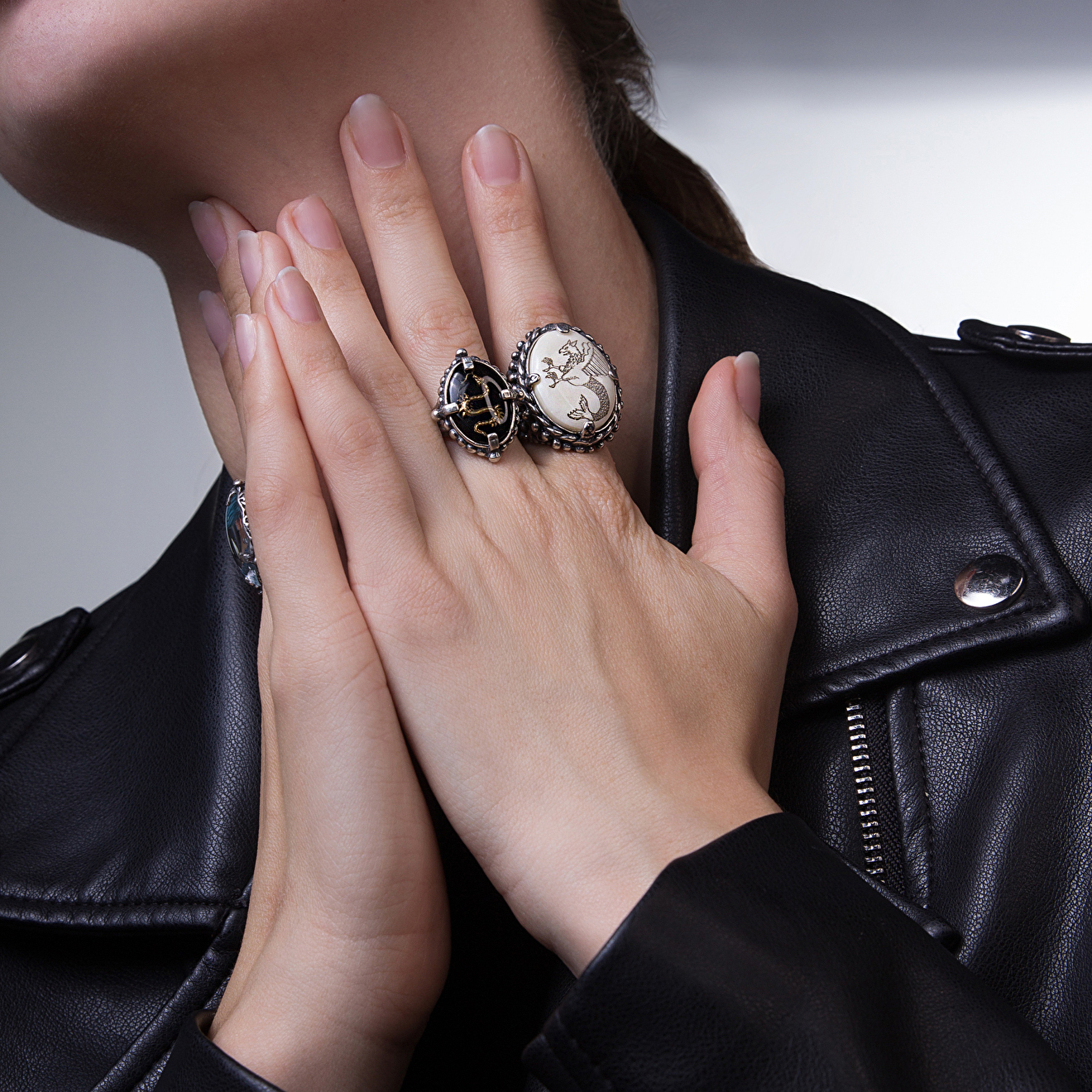 Silver ring with bone and wyvern pattern