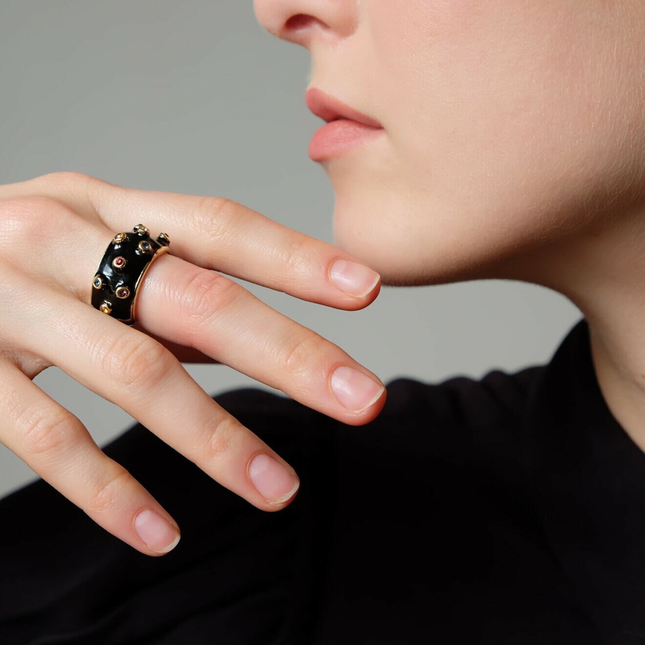 Golden-black ring with colored crystals