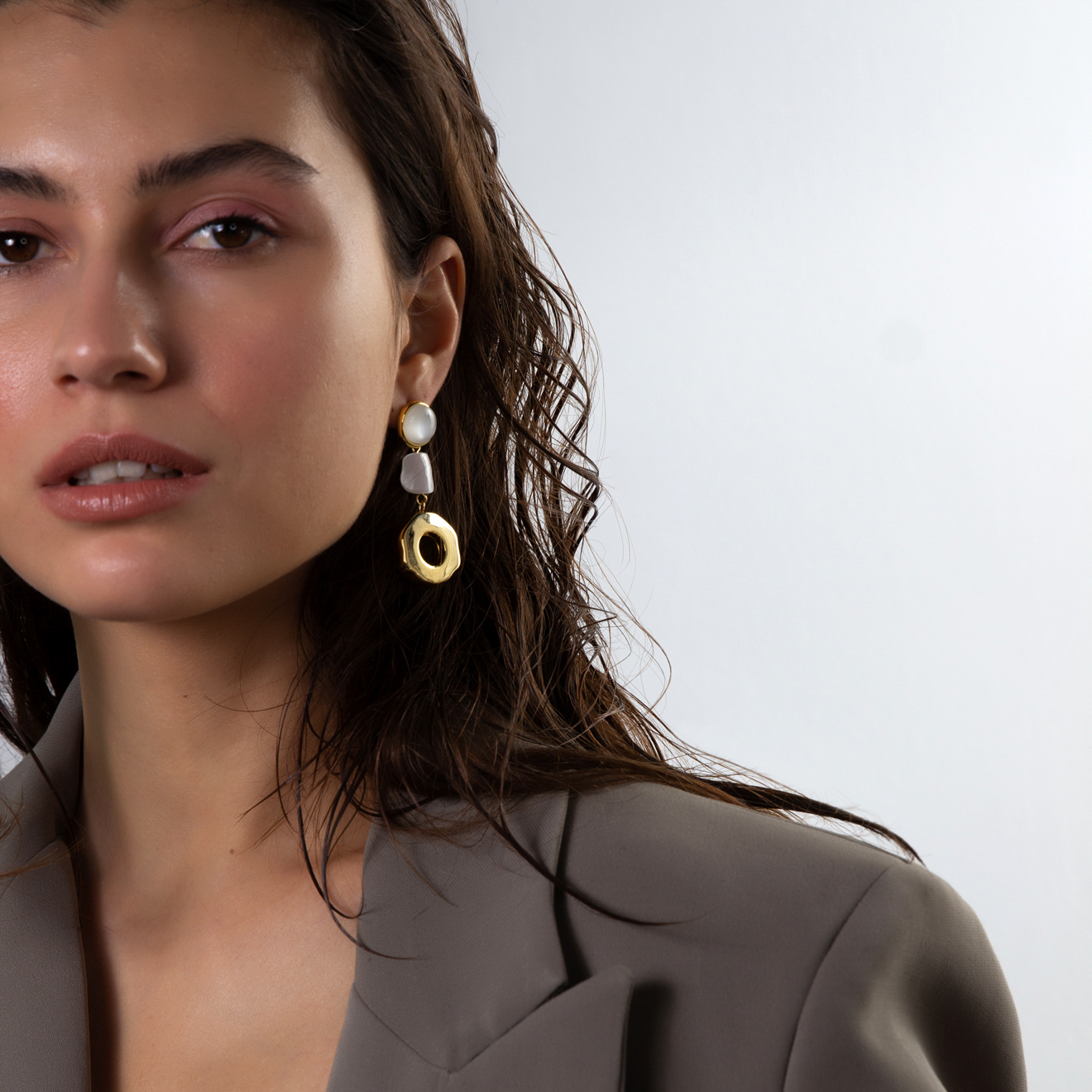 earrings with a light stone and round pendants